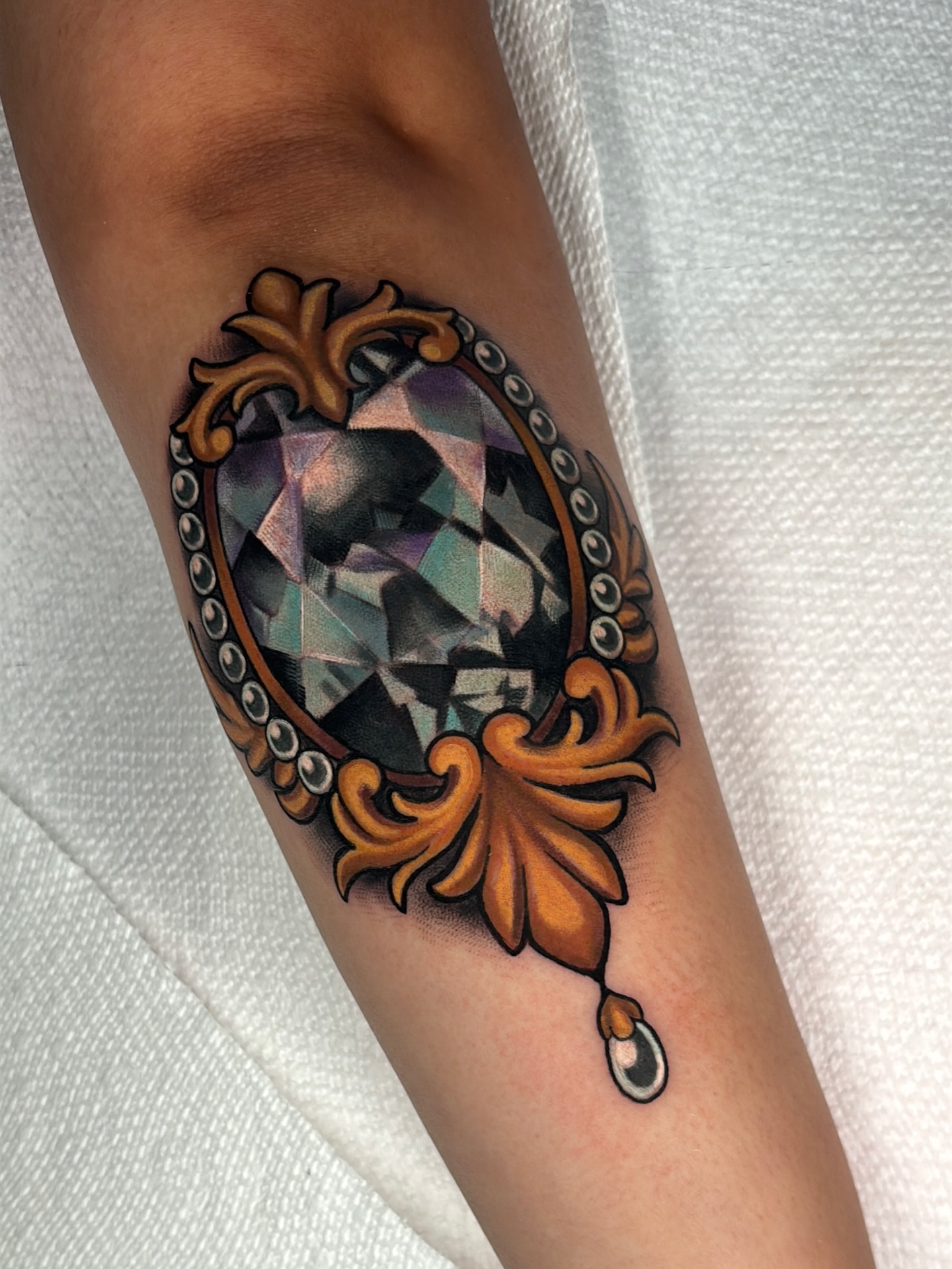 Diamond geometric tattoo on the forearm by Latesha Burnley