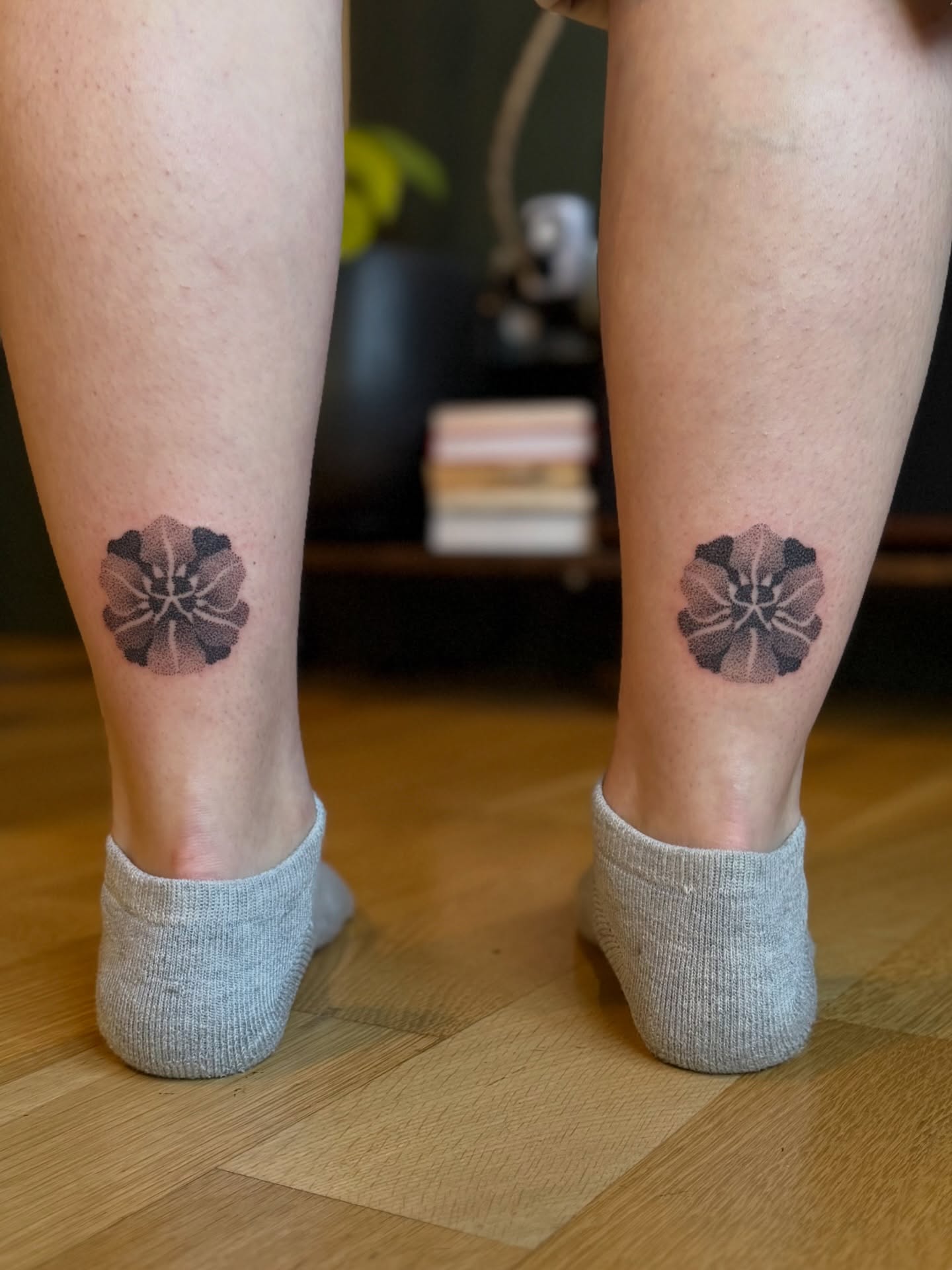 Flower black and grey tattoo on the calf by Alexandra Gray
