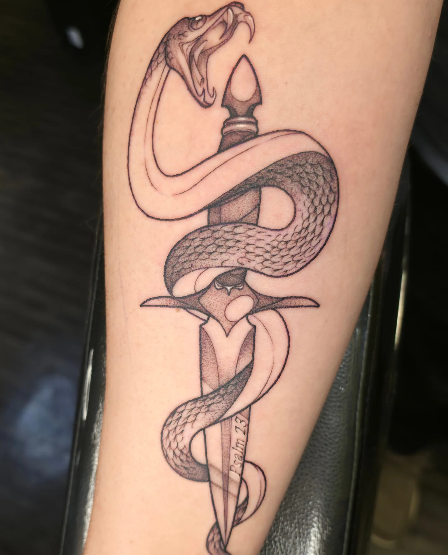 Snake and dagger black and grey tattoo on the forearm by Kennedy Jones, Lee's Summit, Missouri