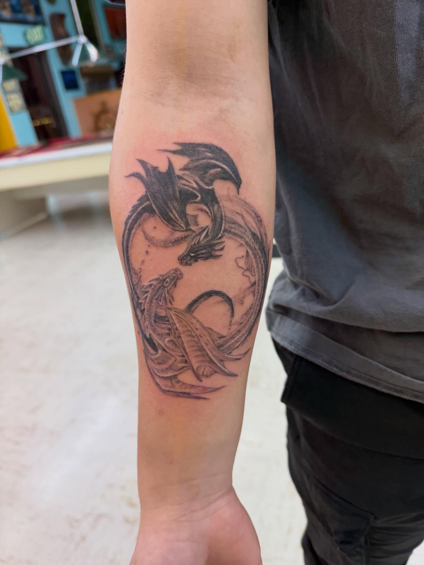 Dragon black and grey tattoo on the forearm by Levi Sawdon, Everett, Washington