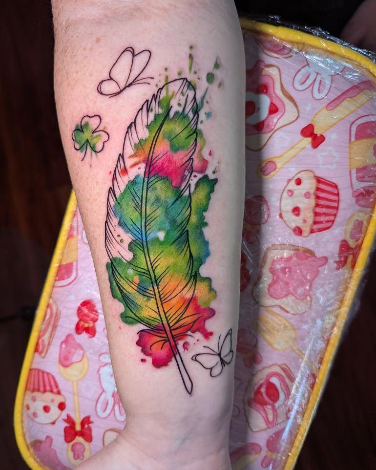 Watercolor feather watercolor tattoo on the forearm by Ricefu Art & Tattoo
