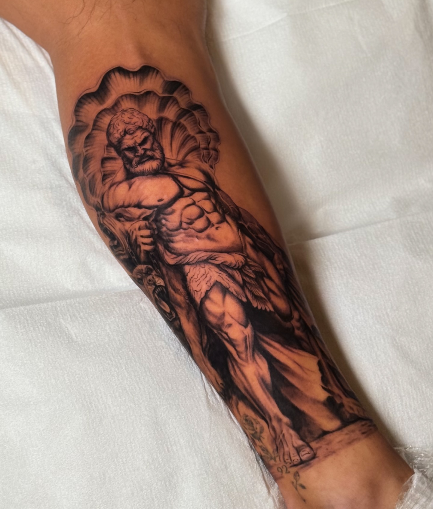 Muscular angel realism tattoo on the forearm by Iryna Polyakhova