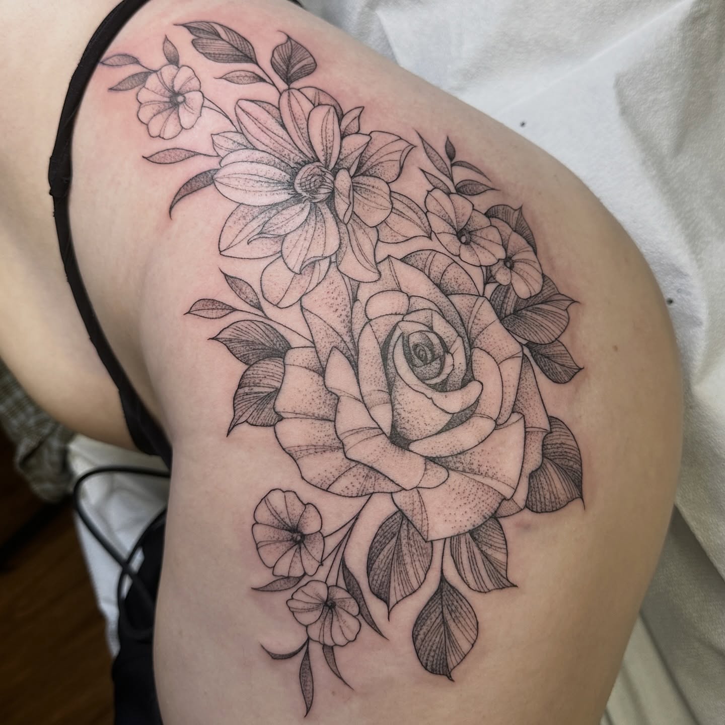 Floral bouquet dotwork tattoo on the shoulder by Robert McCollum