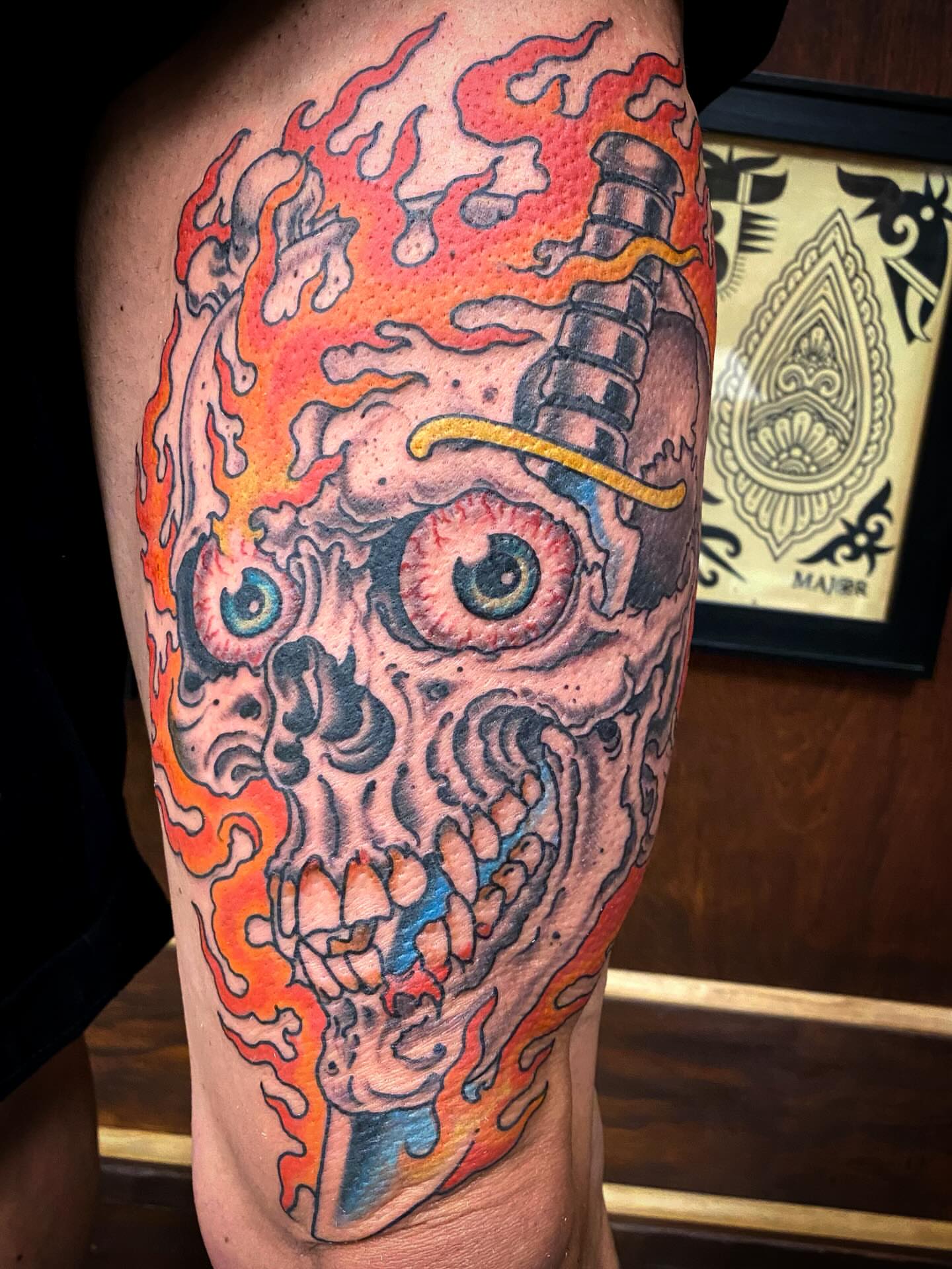 Flaming skull American traditional tattoo on the thigh by Adam Warmerdam, Los Angeles, California