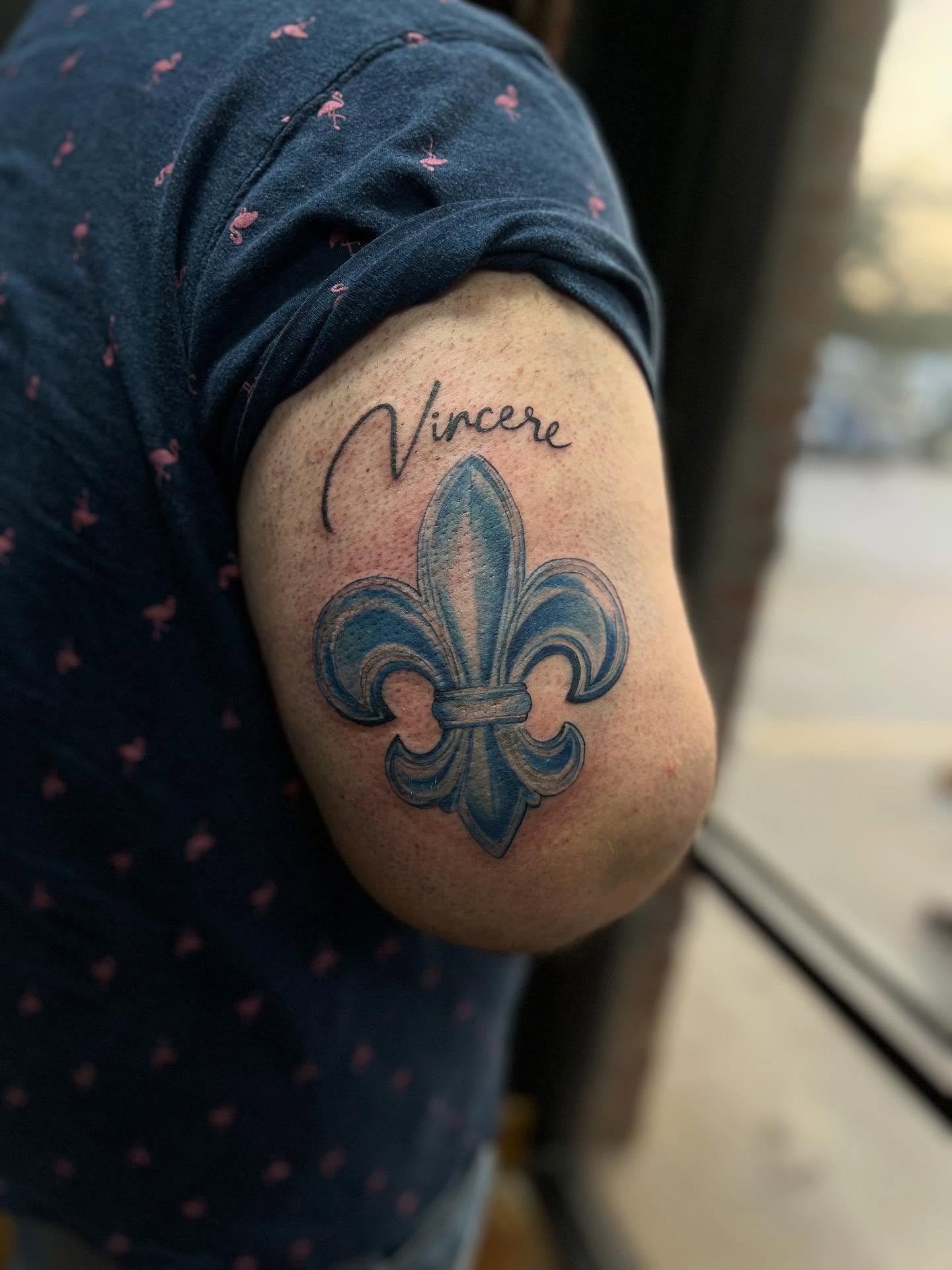 Fleur-de-lis black and grey tattoo on the shoulder by Rebecca Kern Tattoos