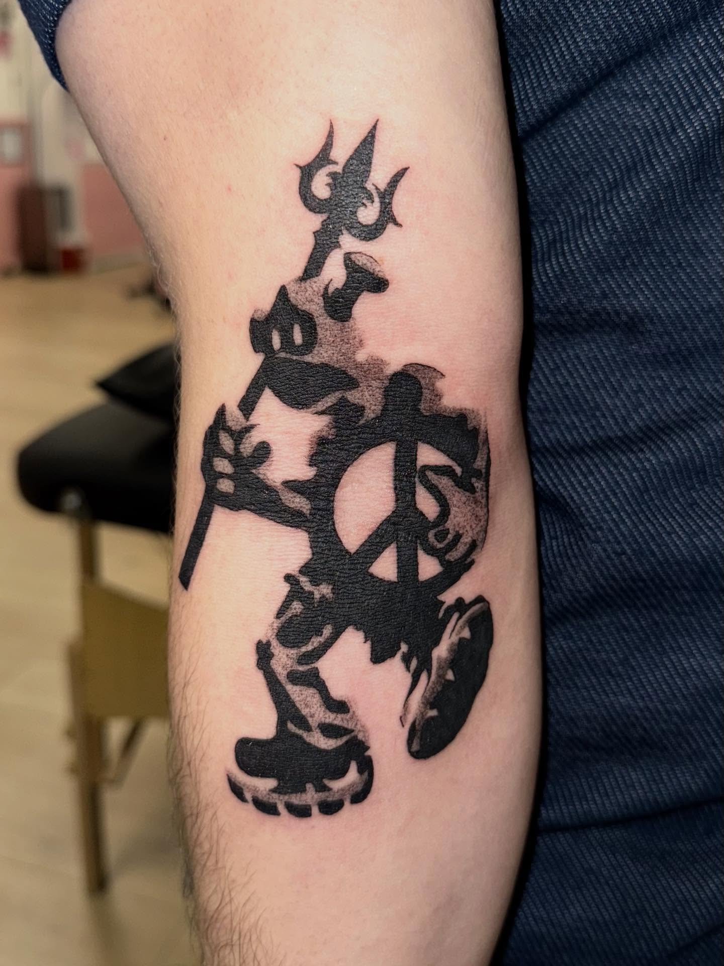 Demon with trident black and grey tattoo on the forearm by Laurito