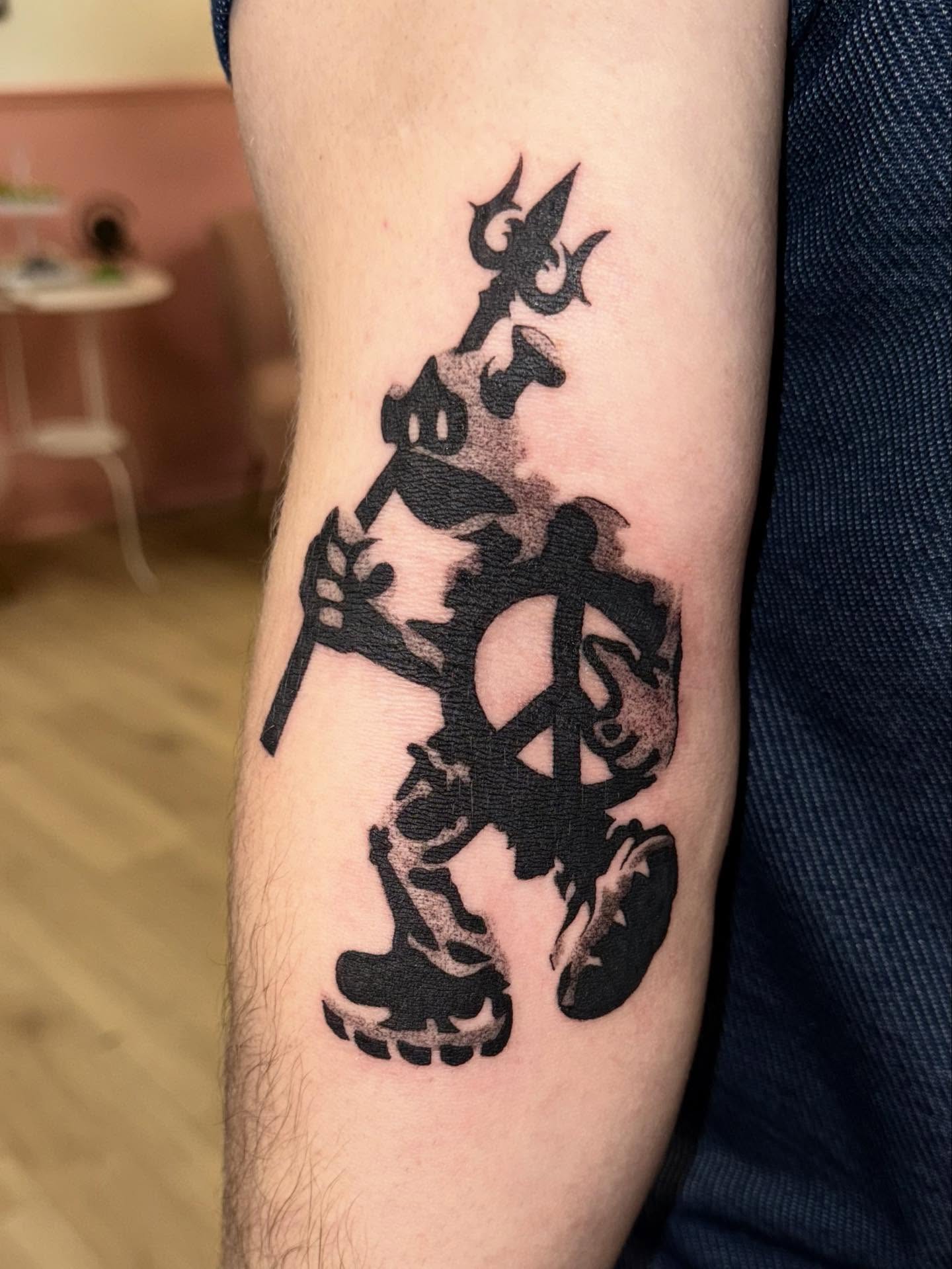 Skull and peace sign black and grey tattoo on the forearm by Laurito