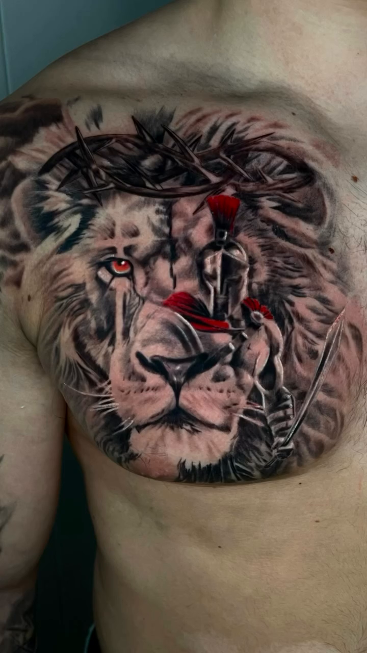 Lion with crown of thorns realism tattoo on the forearm by Tattoo Artist