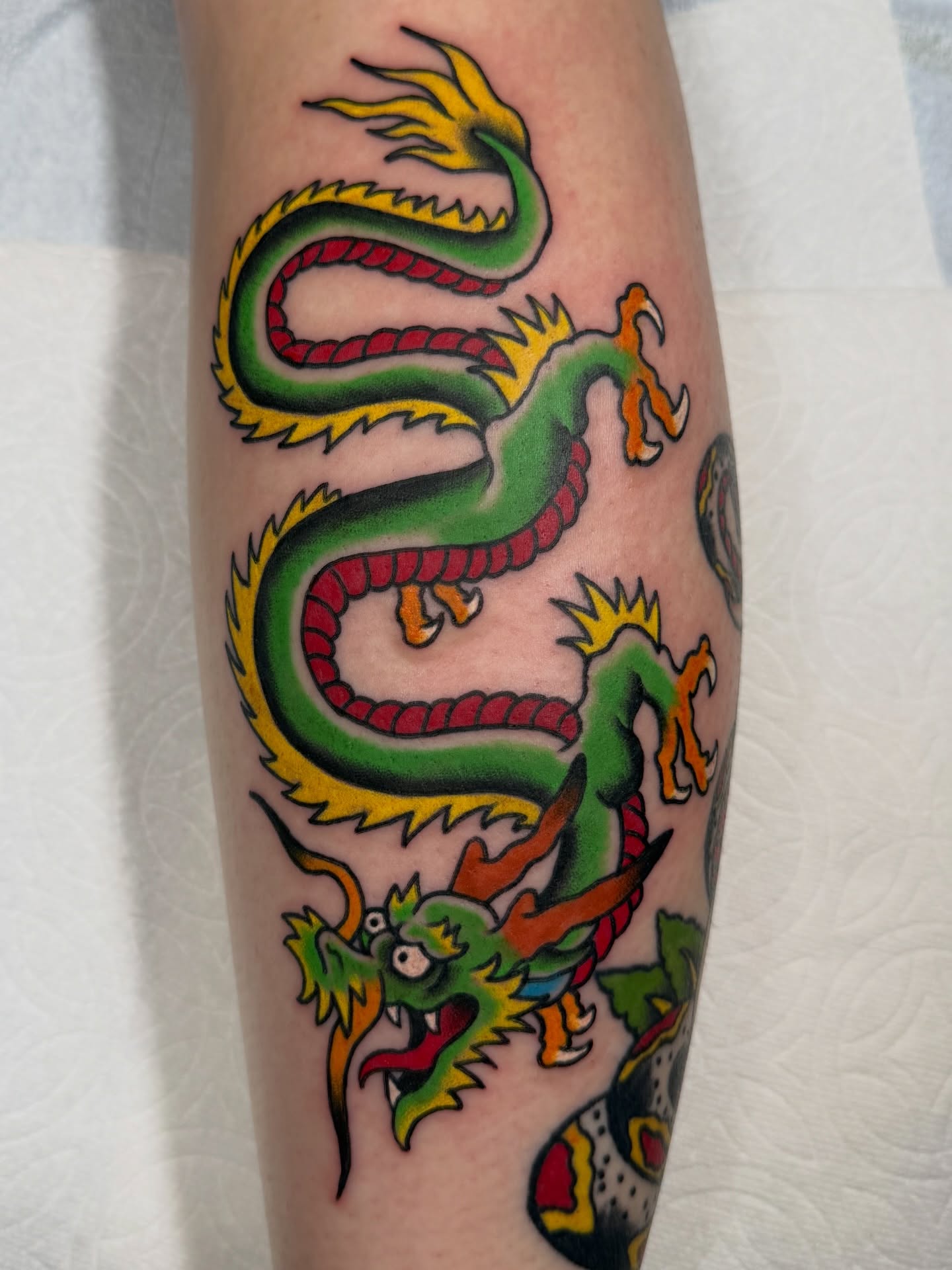Dragon American traditional tattoo on the forearm by Trevor Berry