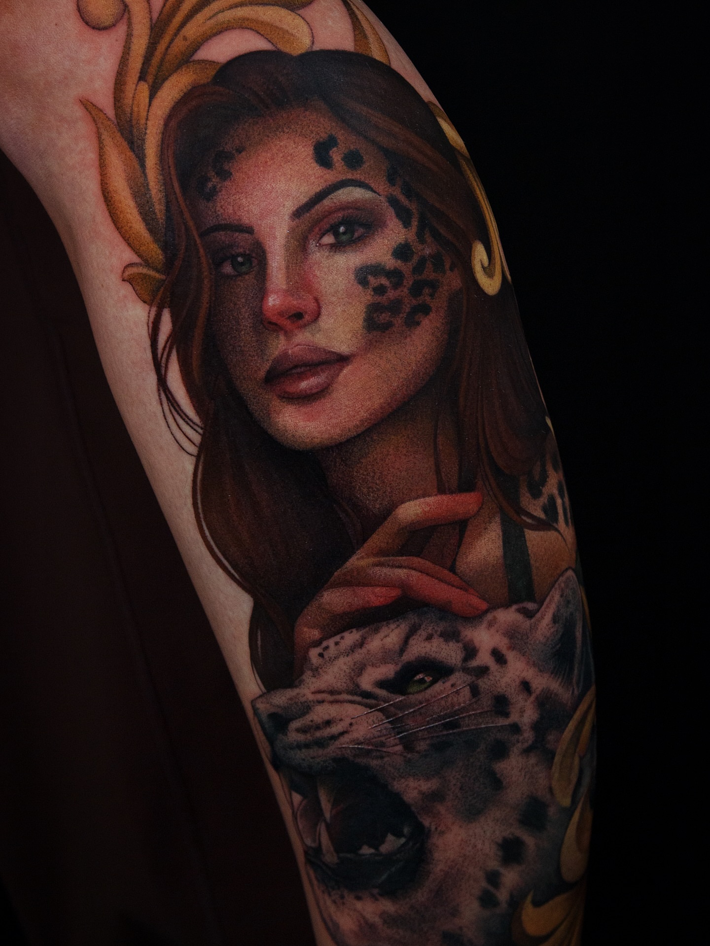 Woman with leopard realism tattoo on the forearm by caliope yiannos