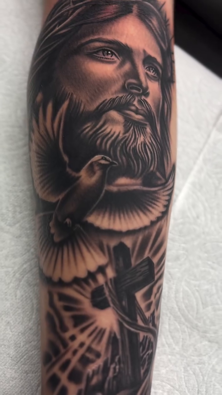 Jesus Christ with dove and cross realism tattoo by Alex Romero