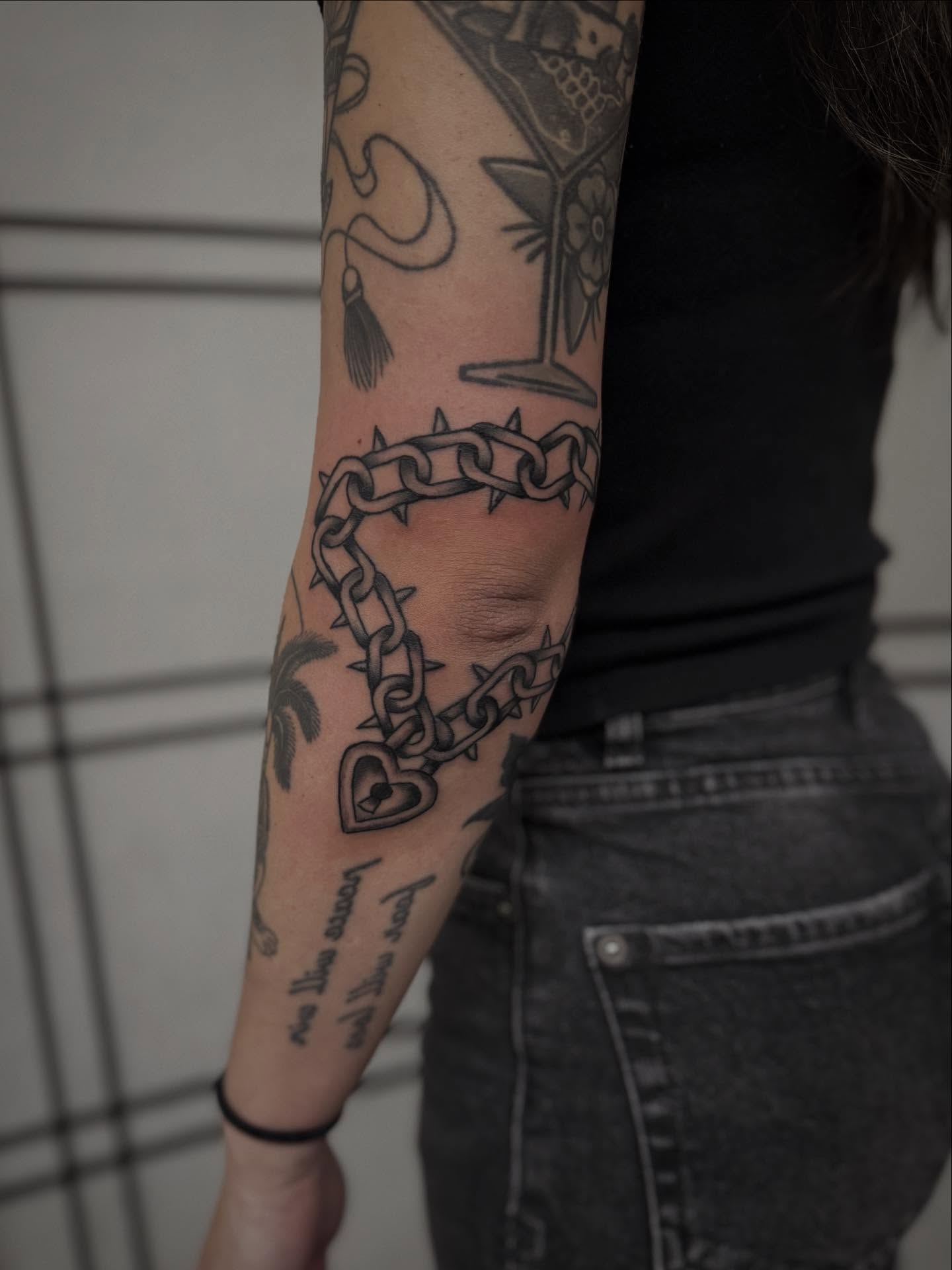 Chain black and grey tattoo on the forearm by Micah Norman, San Francisco, California