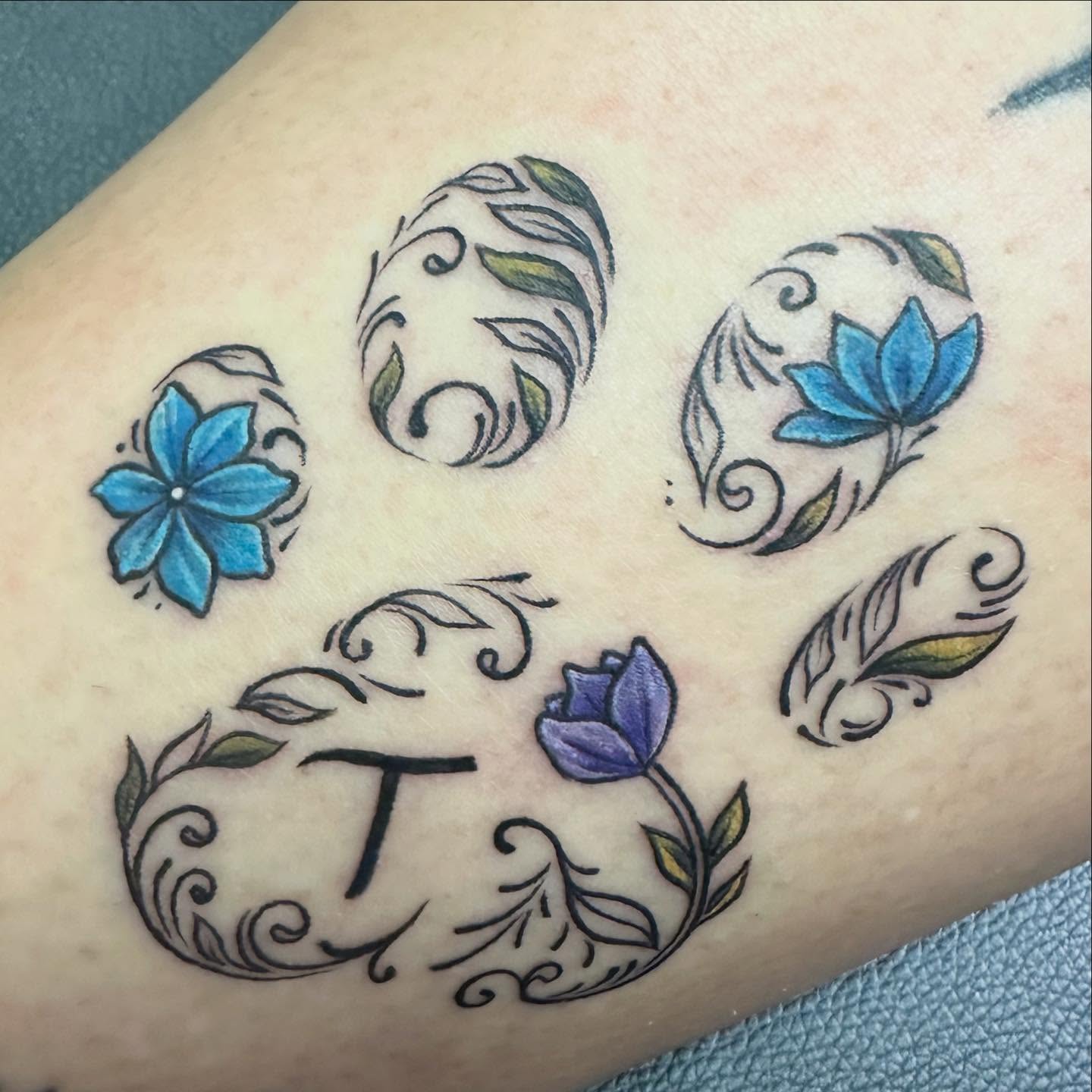 Floral motifs ornamental tattoo on the forearm by Sarah Nash