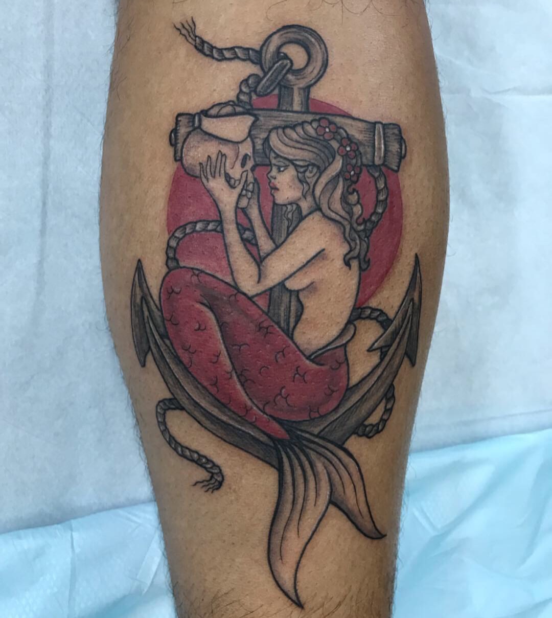 Mermaid with anchor American traditional tattoo on the leg by Carmen Figueroa, New York, New York