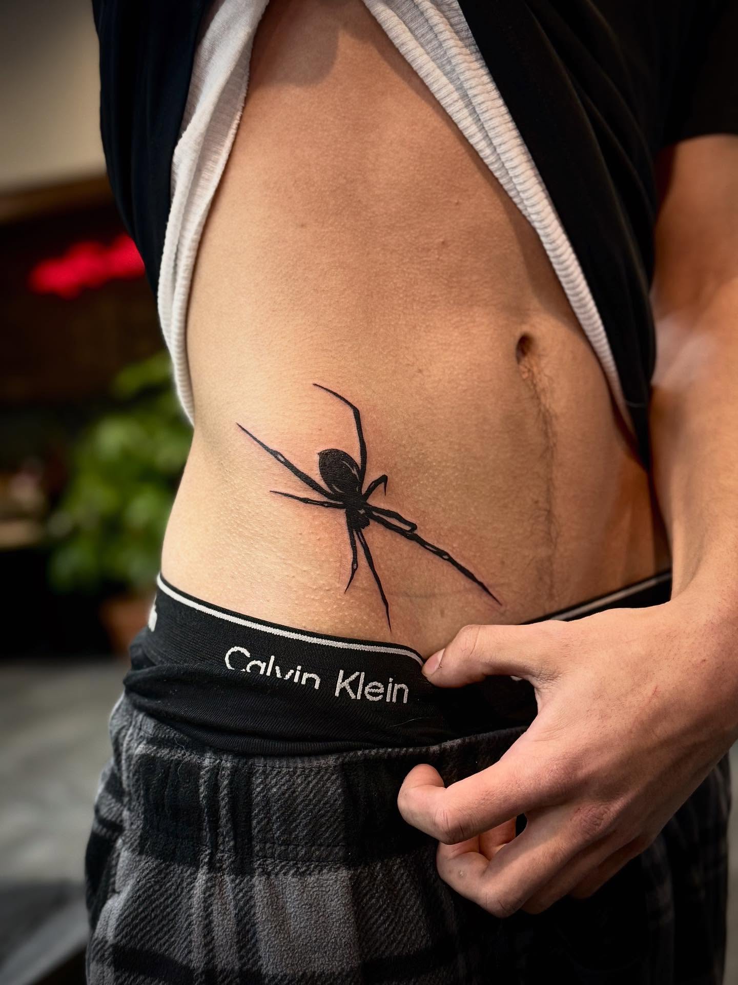 Spider black and grey tattoo on the ribs by Ashley Kayser