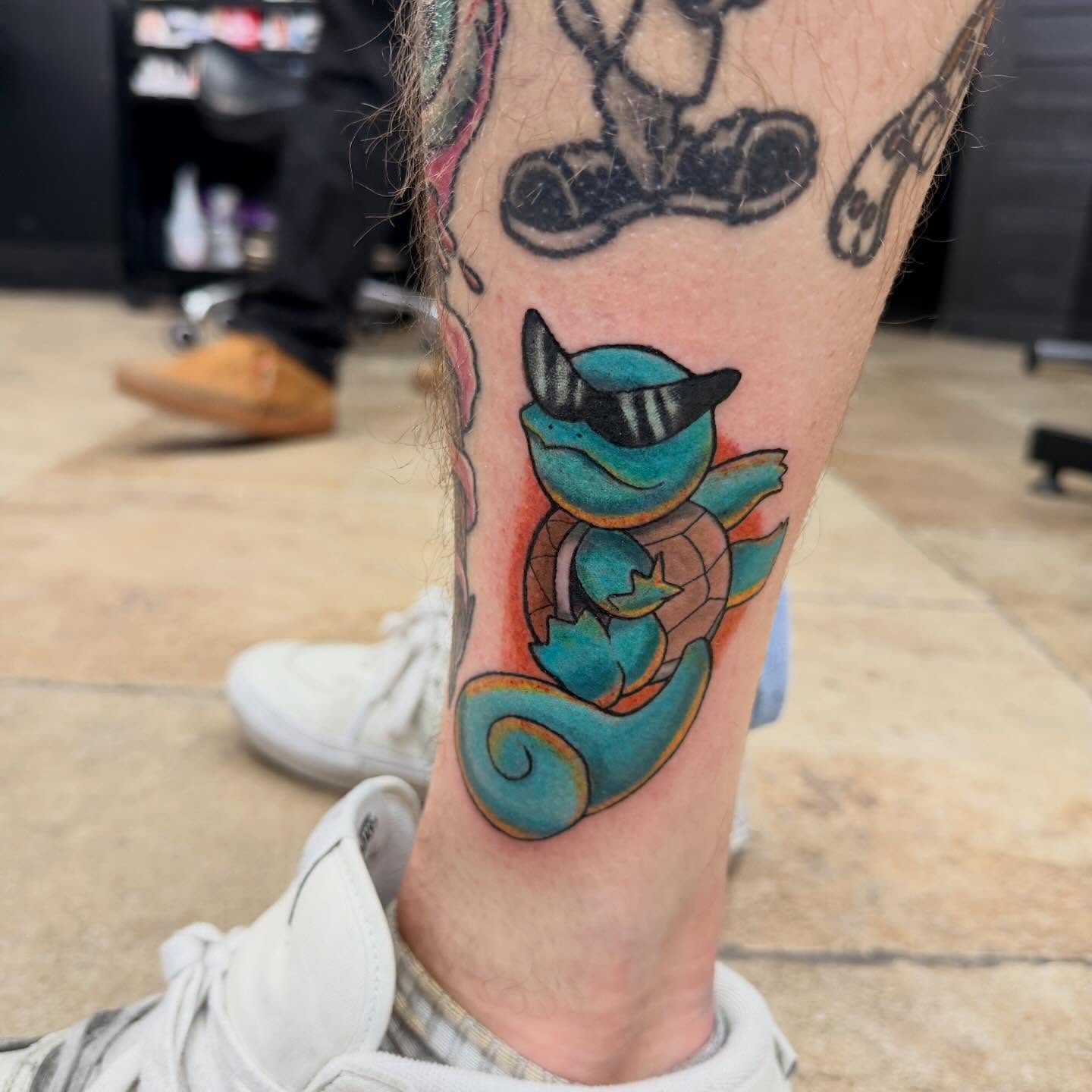 Squirtle new school tattoo on the calf by Ellari