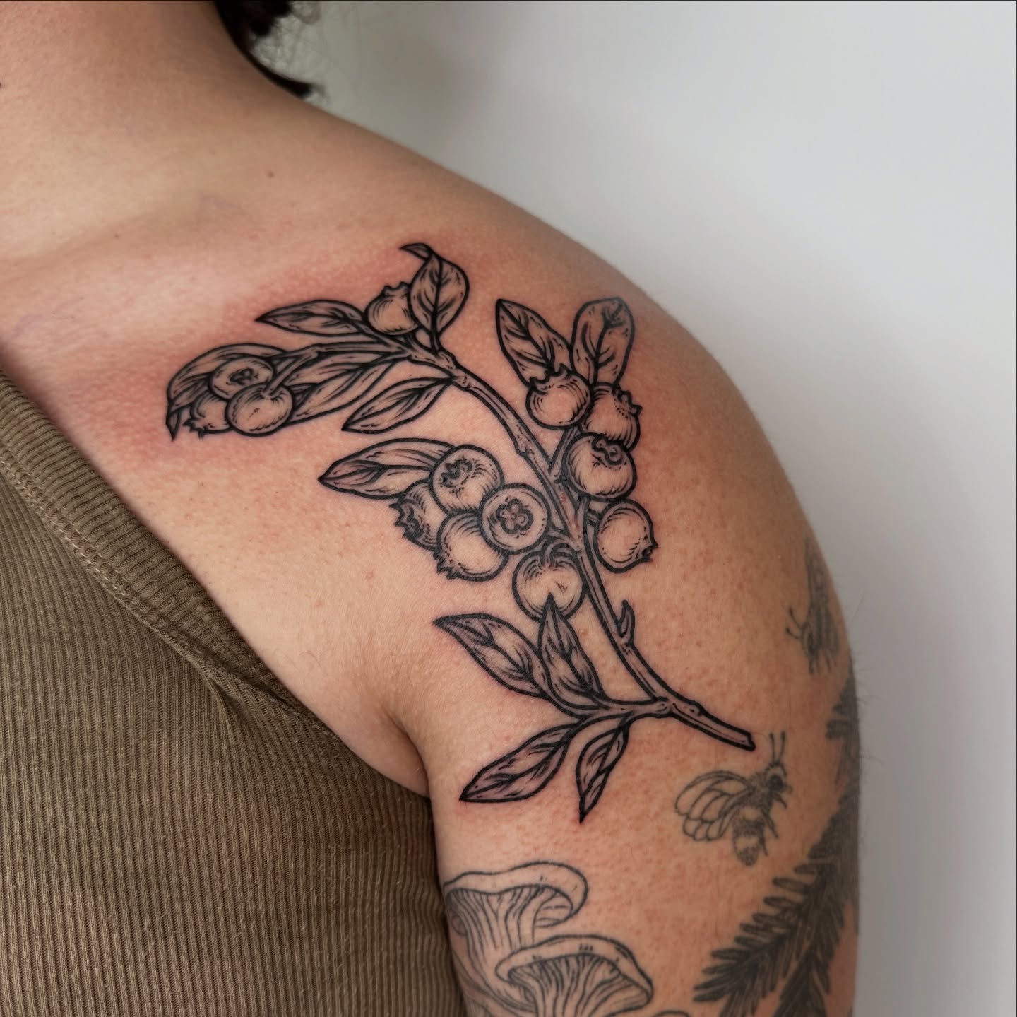 Blueberry branch black and grey tattoo on the shoulder by rosalie
