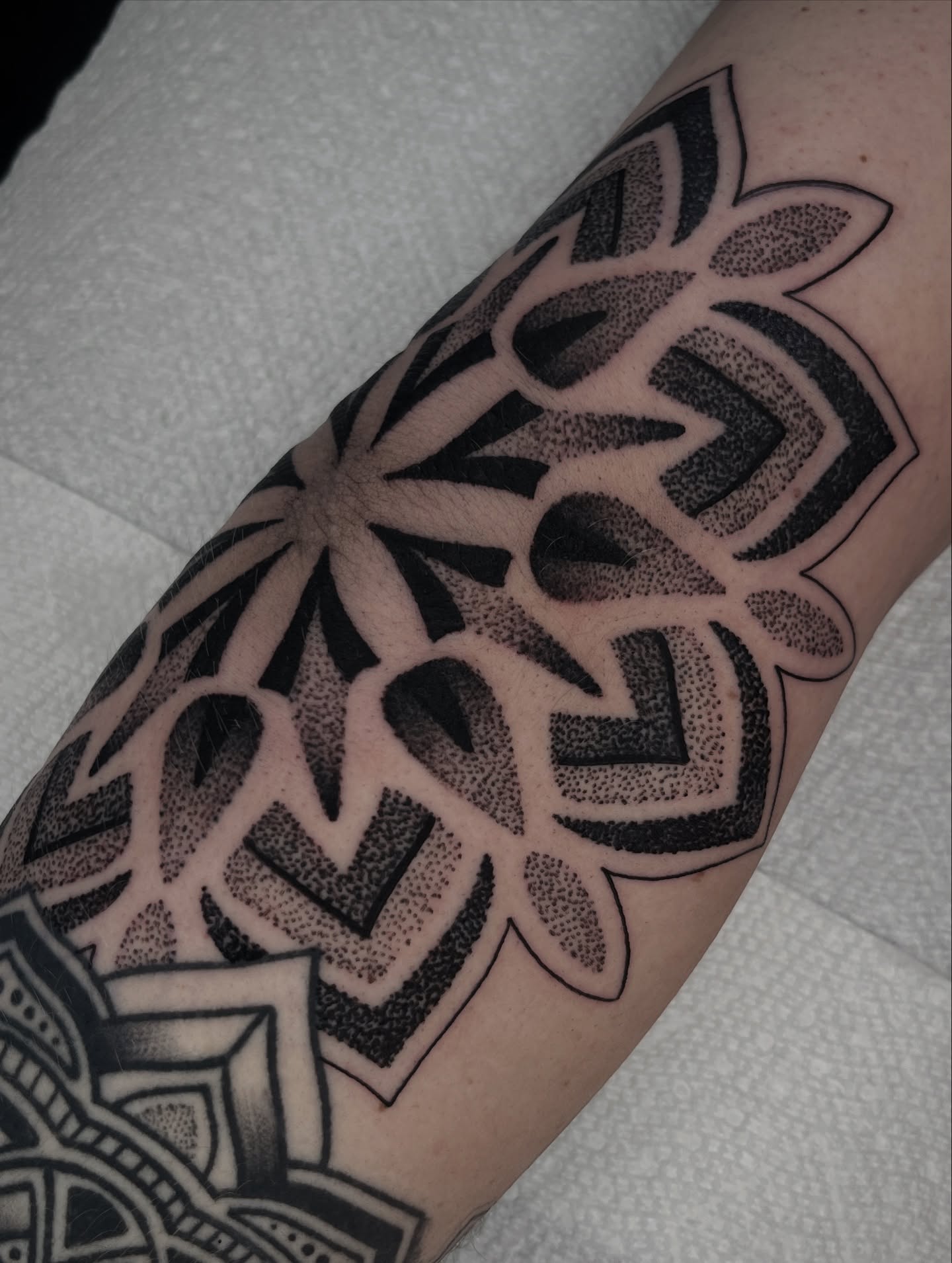 Geometric pattern dotwork tattoo on the forearm by Jordan Hunt