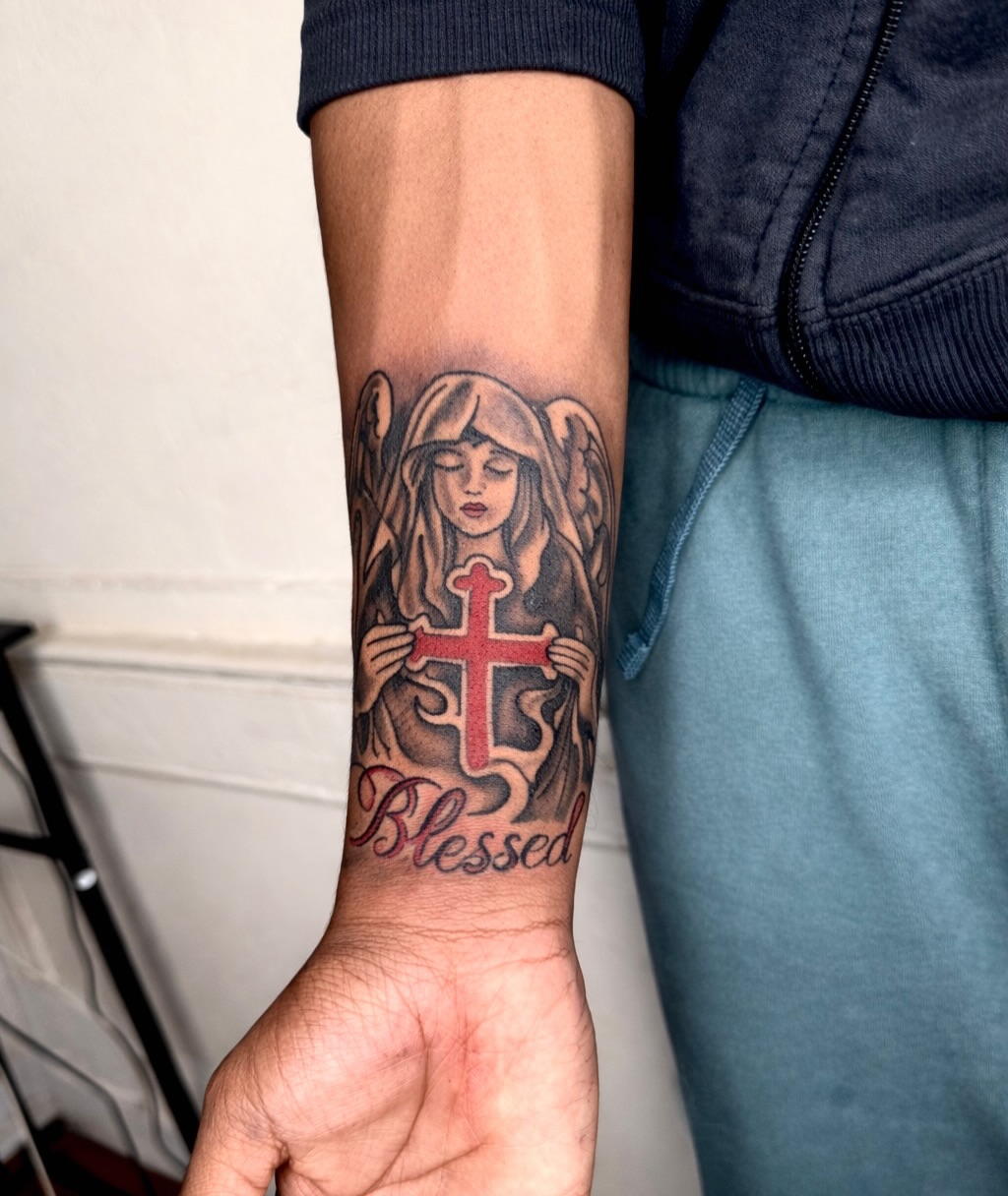 Angel holding cross neo-traditional tattoo on the forearm by JayyeSosa