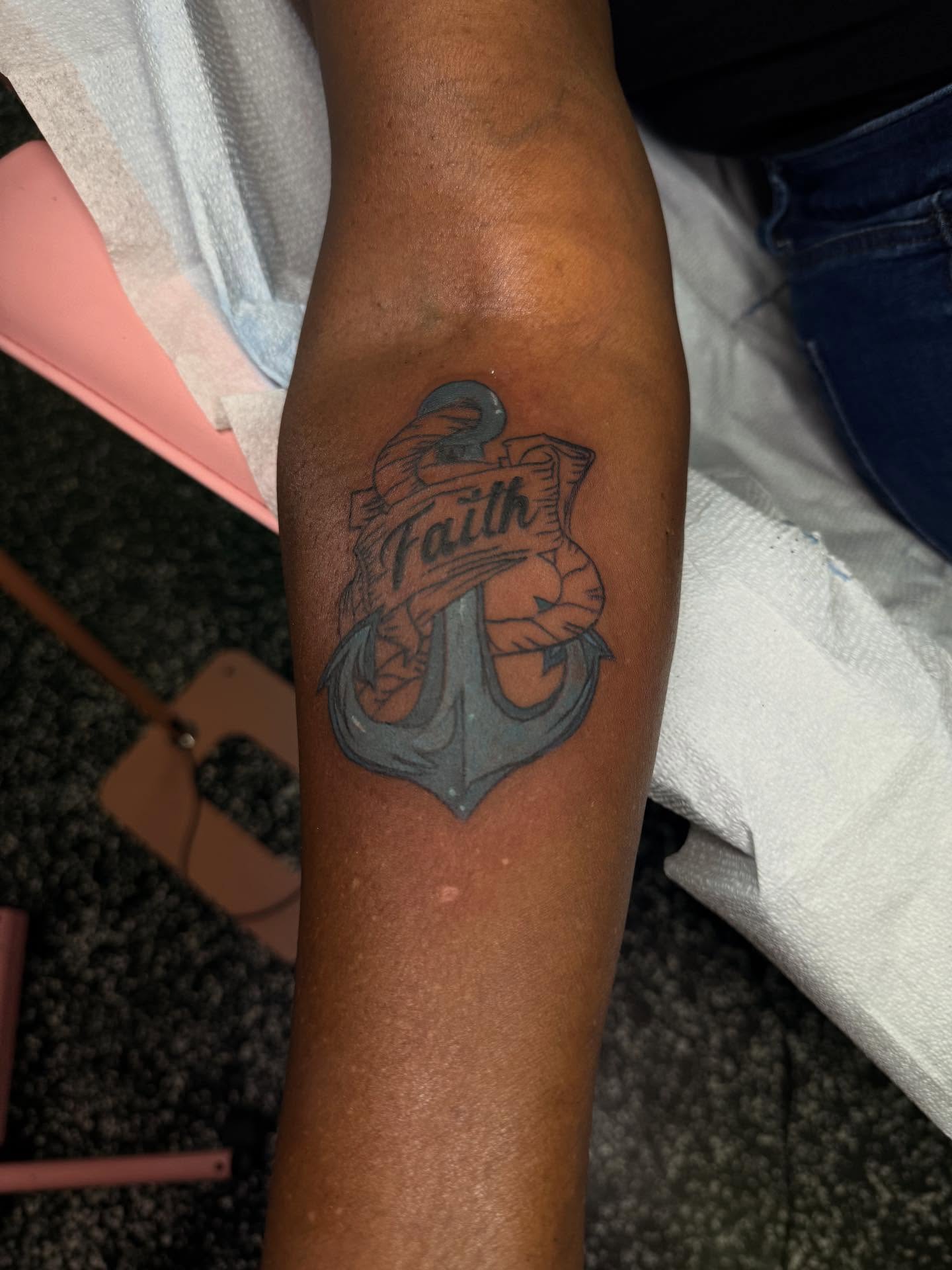 Anchor with banner black and grey tattoo on the forearm by Tattoos by Santos