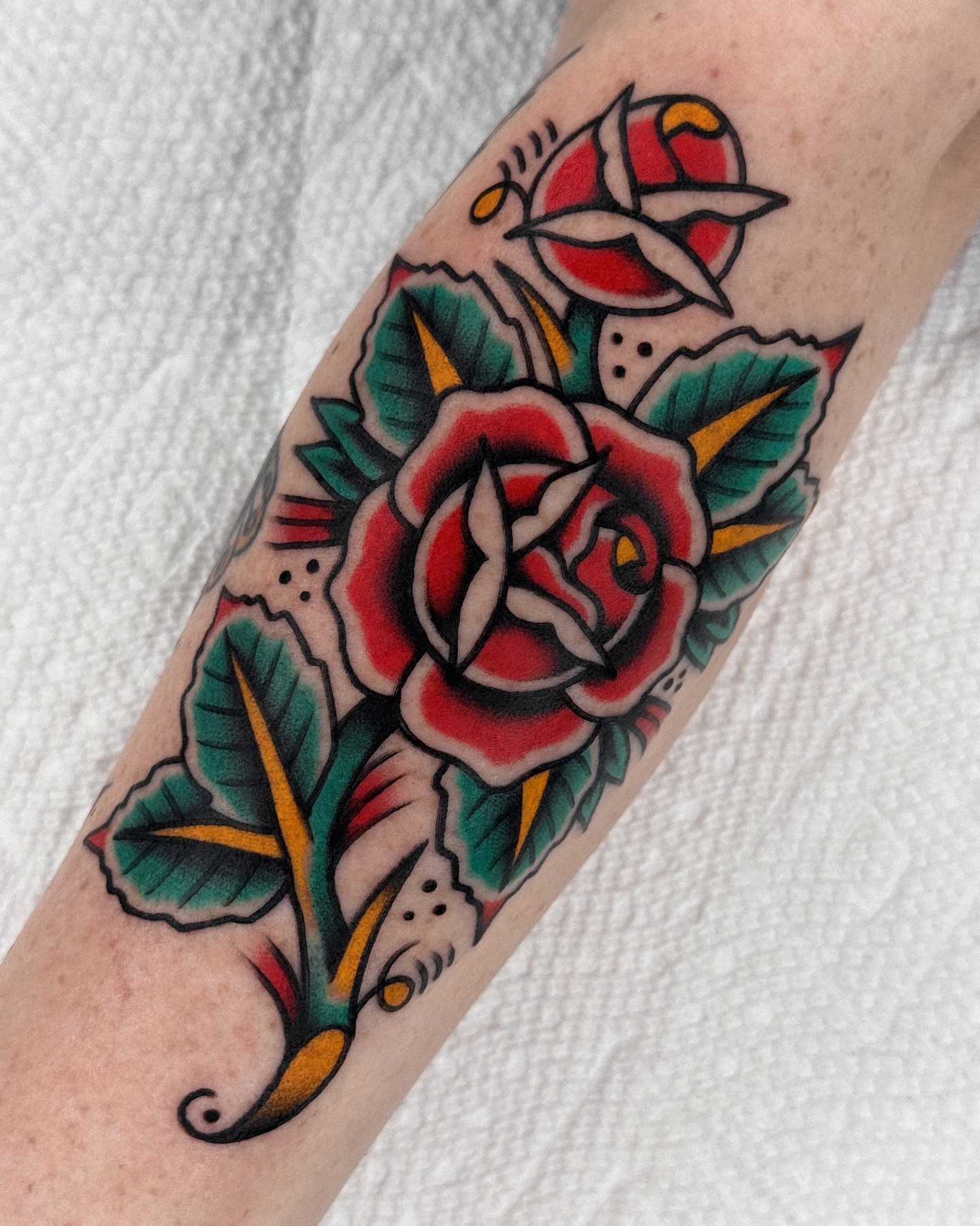Rose American traditional tattoo on the forearm by Samuel Dickey