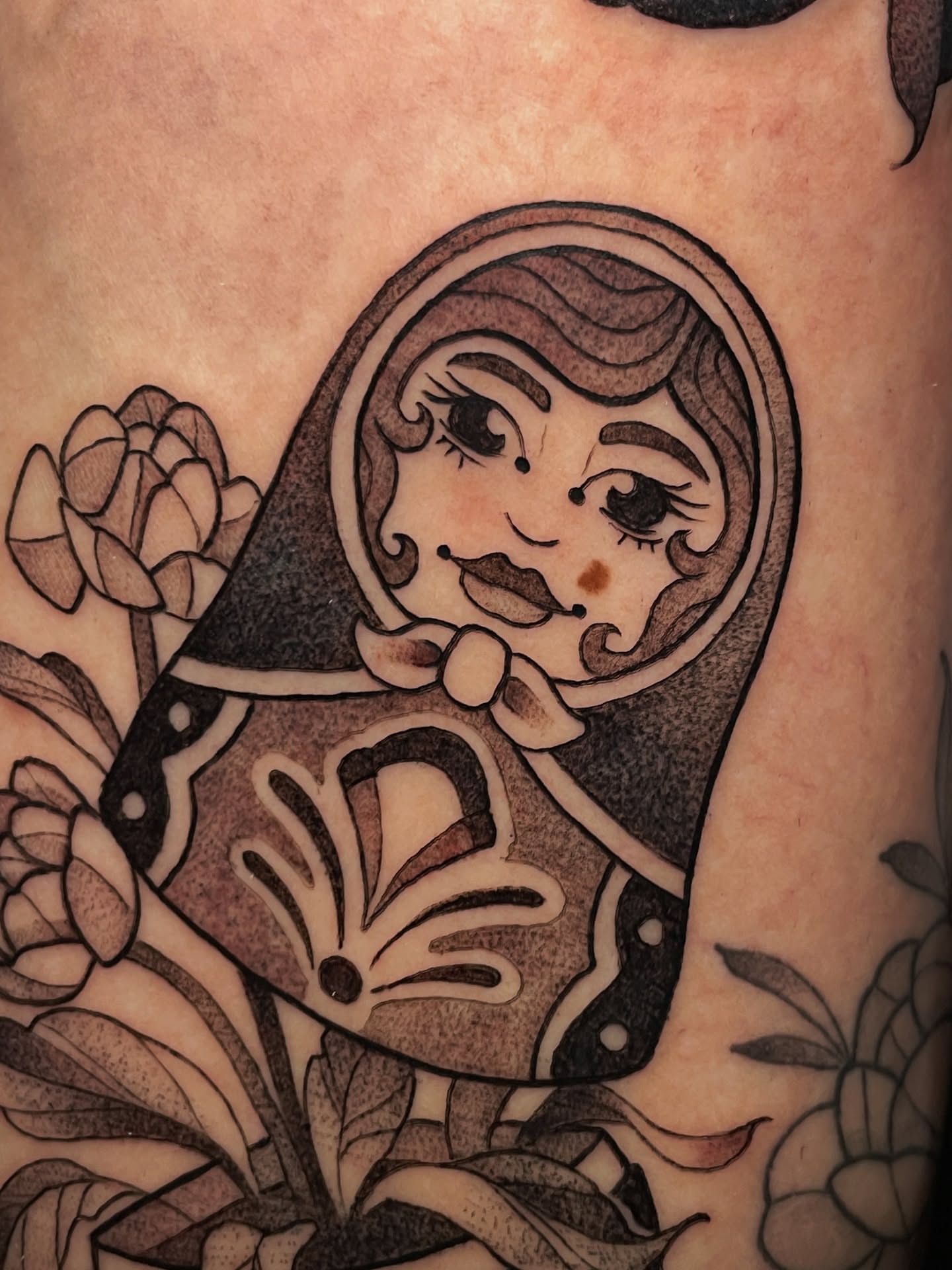 Matryoshka doll black and grey tattoo on the forearm by Tanya Murski