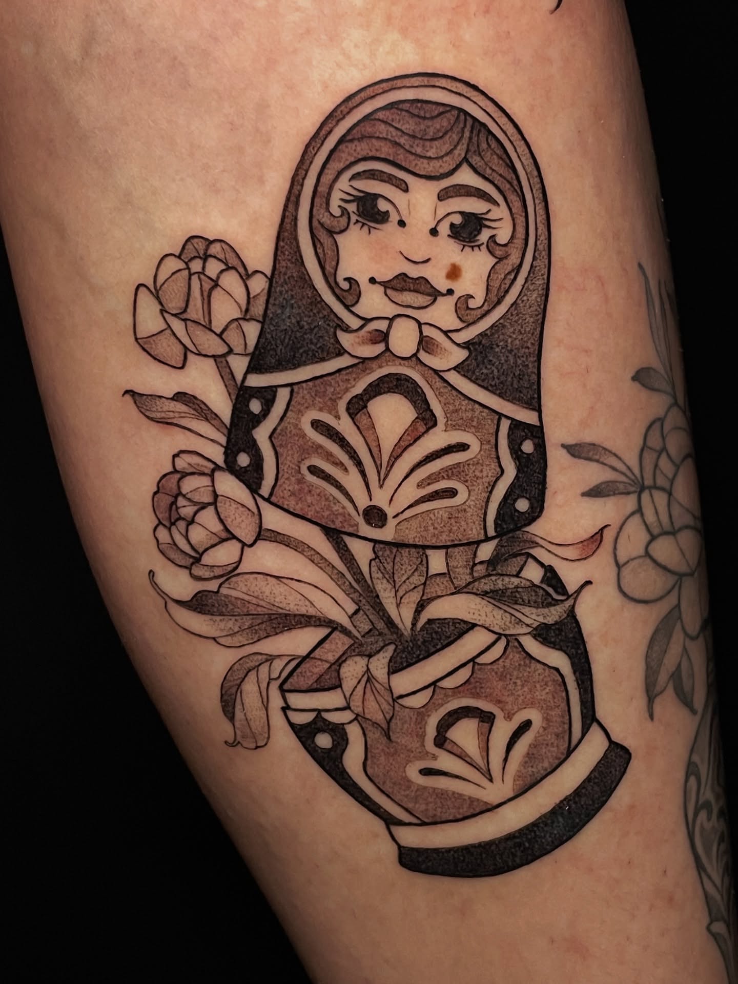 Matryoshka doll black and grey tattoo on the thigh by Tanya Murski