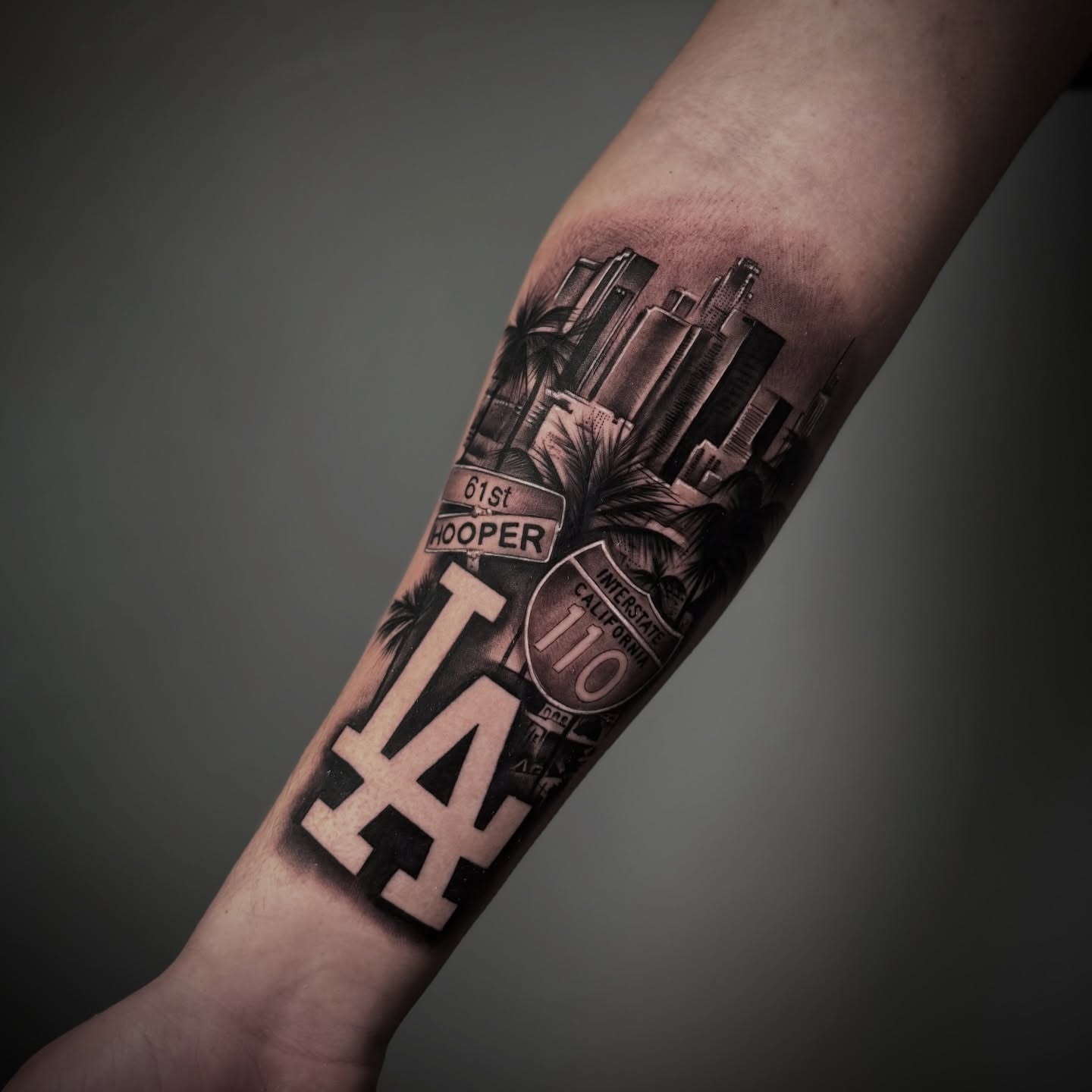 LA skyline realism tattoo on the forearm by π·ππ