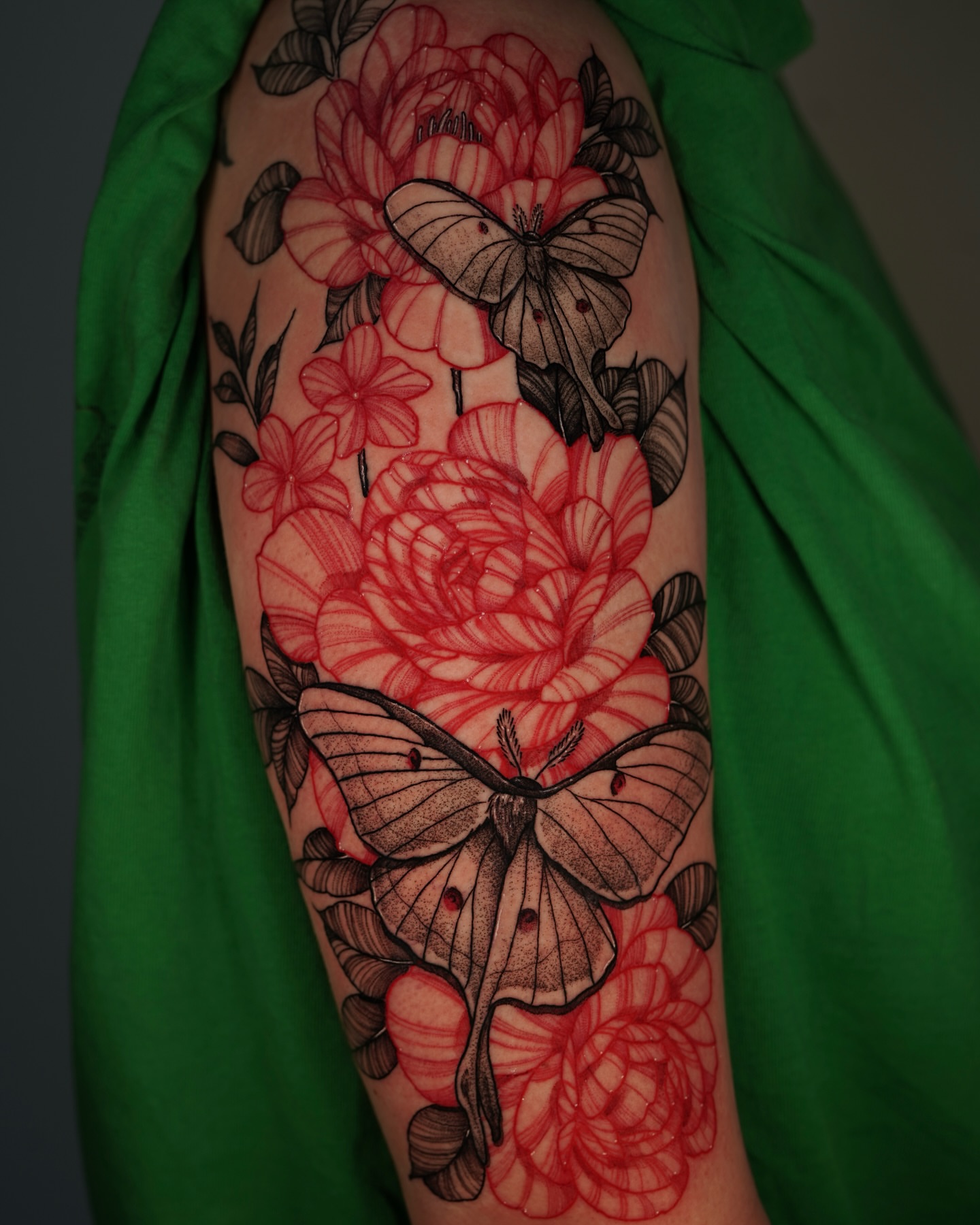 Butterflies and roses neo-traditional tattoo on the upper arm by Tony Murray