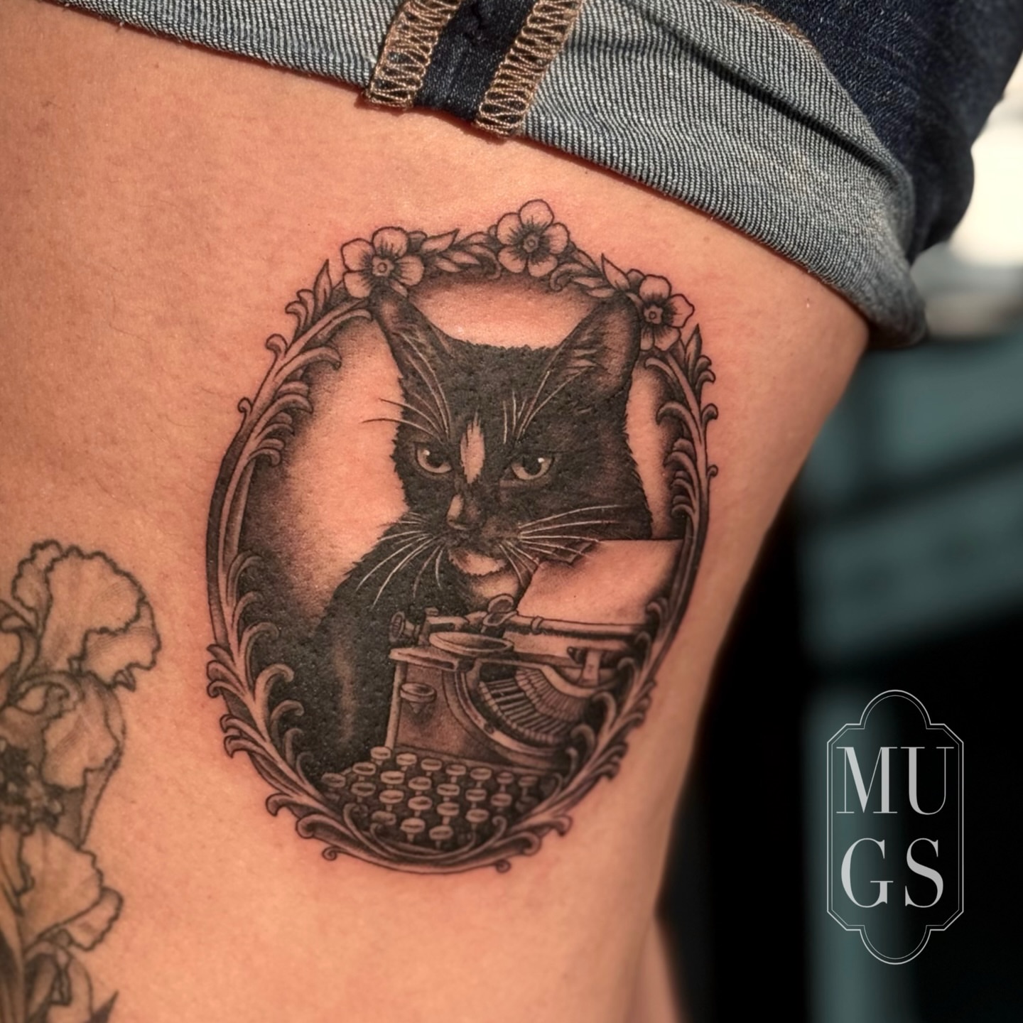 Cat with typewriter realism tattoo on the thigh by Emily Andreozzi
