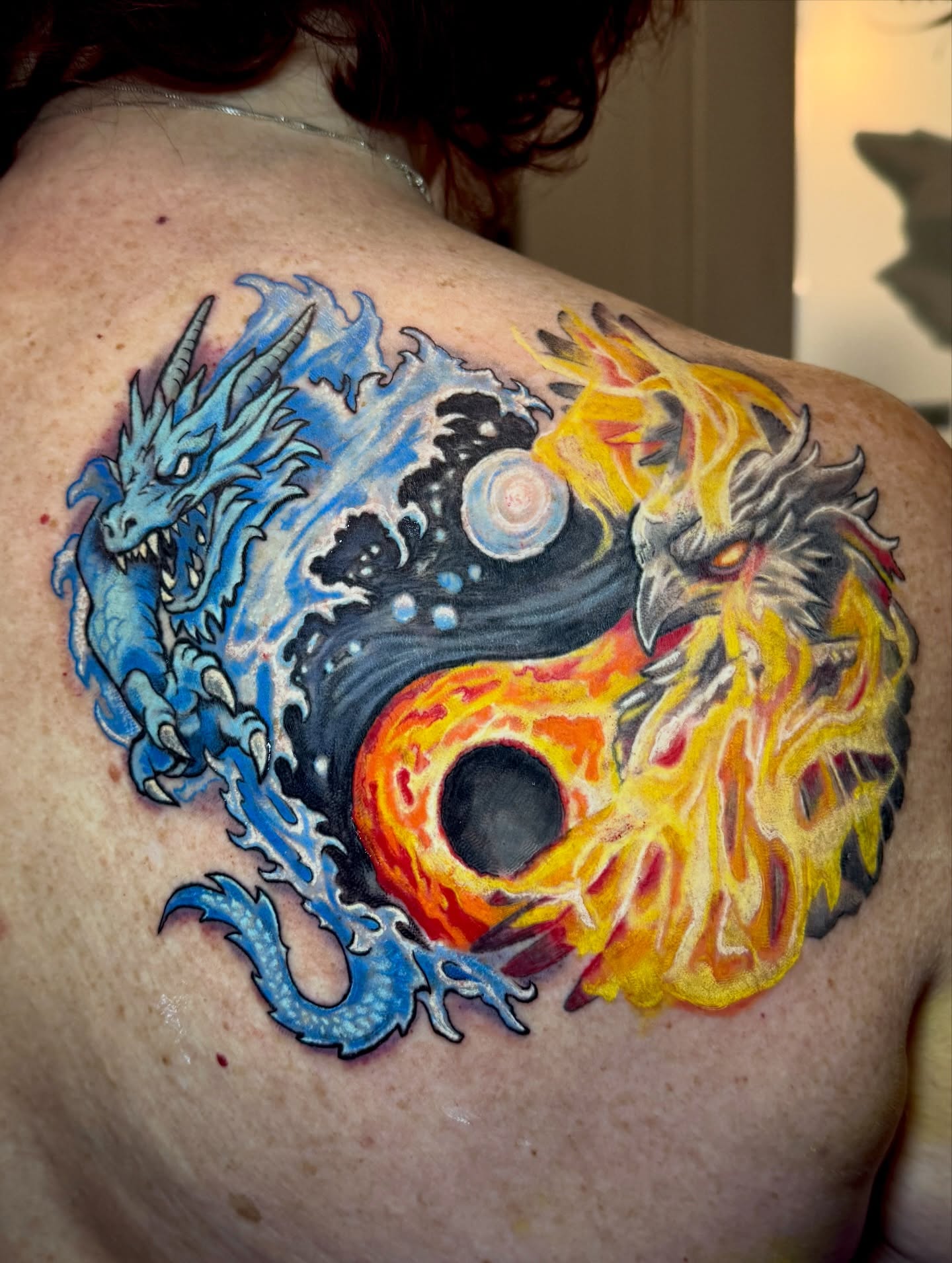 Yin yang with dragon and phoenix japanese irezumi tattoo on the shoulder by Jarrod Gatzke