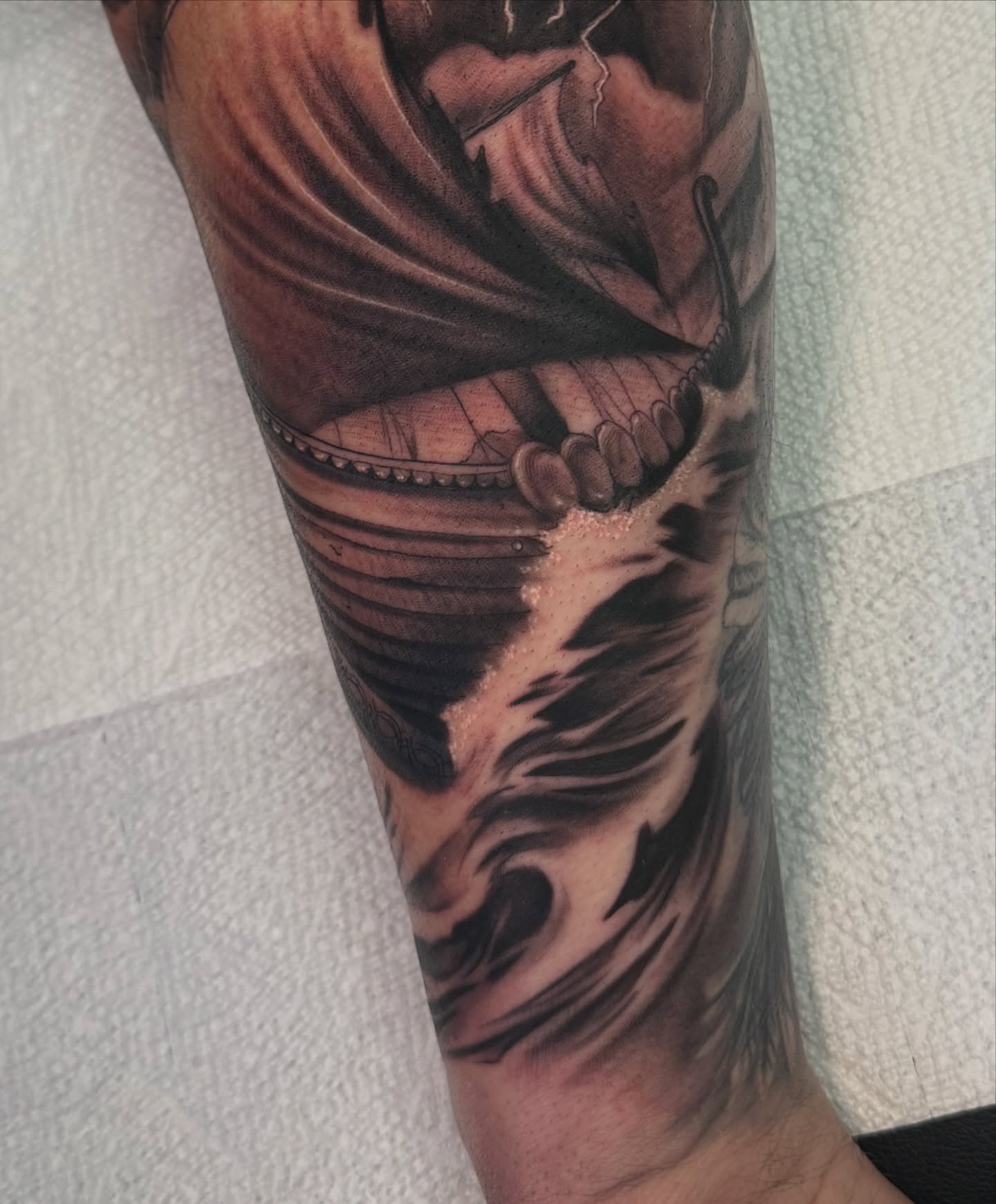 Winged warrior dark realism tattoo on the forearm by Christian Hood