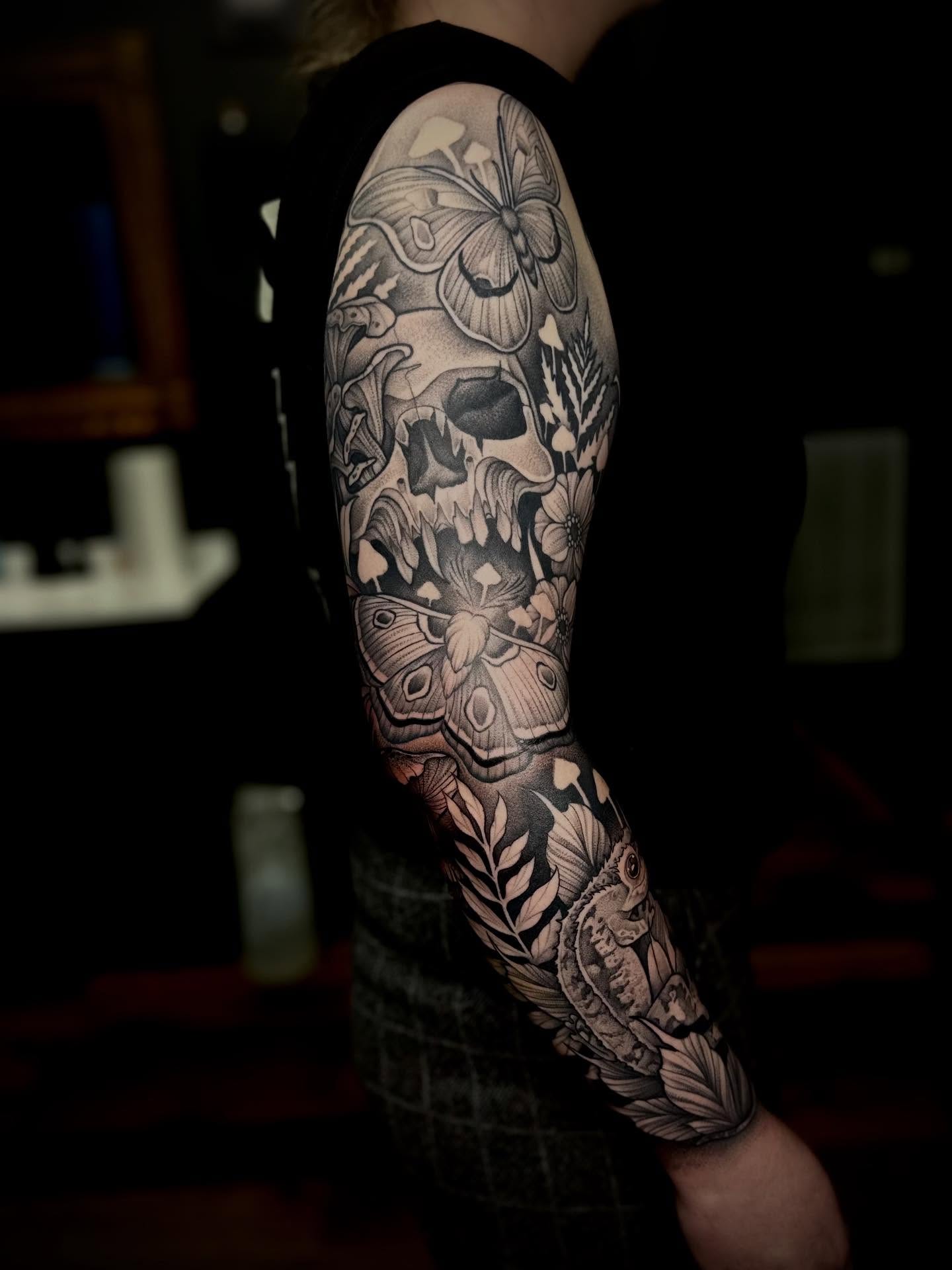 Skull and butterflies realism tattoo on the forearm by Madison Orchard Tattoos