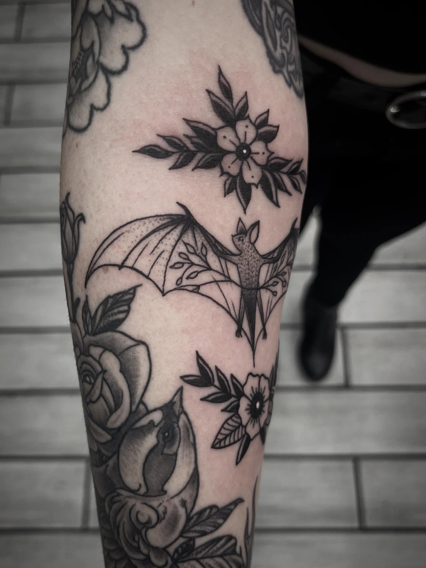Bat and flower American traditional tattoo on the forearm by Sean Gallagher