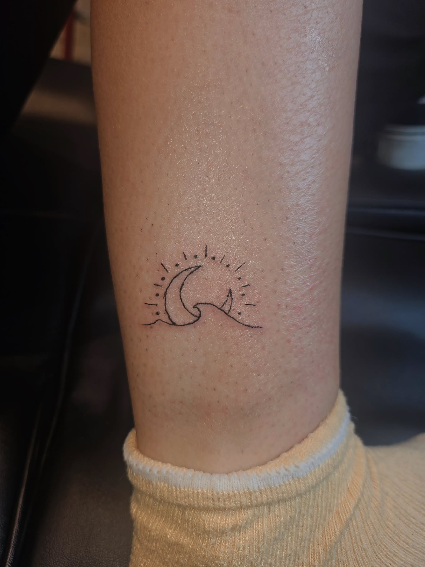 Sun and crescent moon minimalist tattoo on the forearm by ݁˖