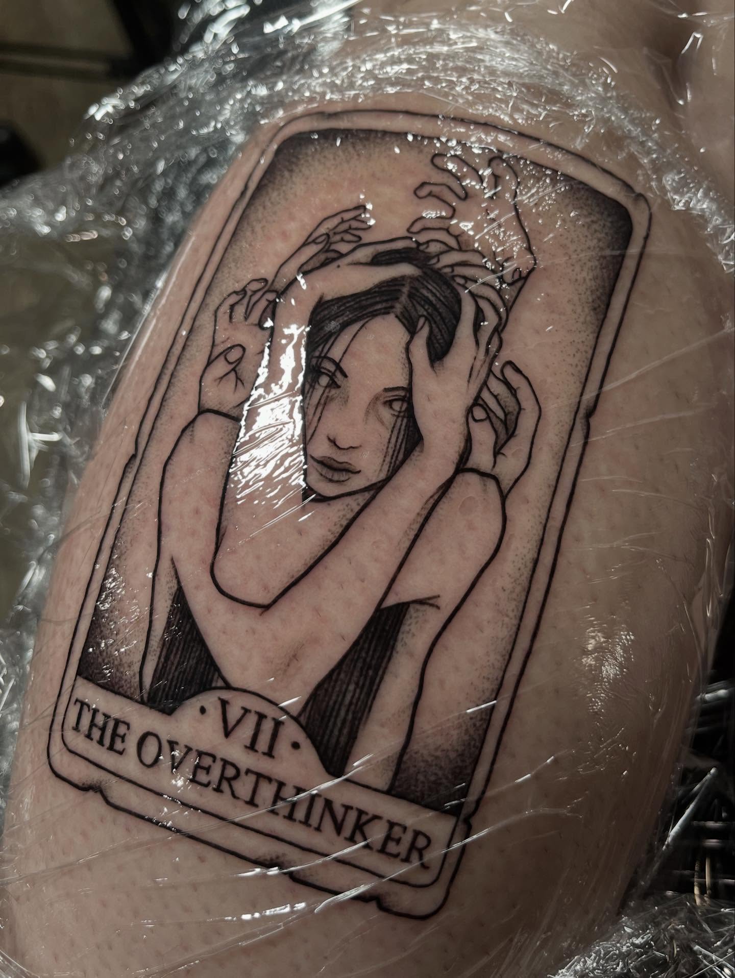 The overthinker black and grey tattoo on the upper arm by Ty’s Tattoos