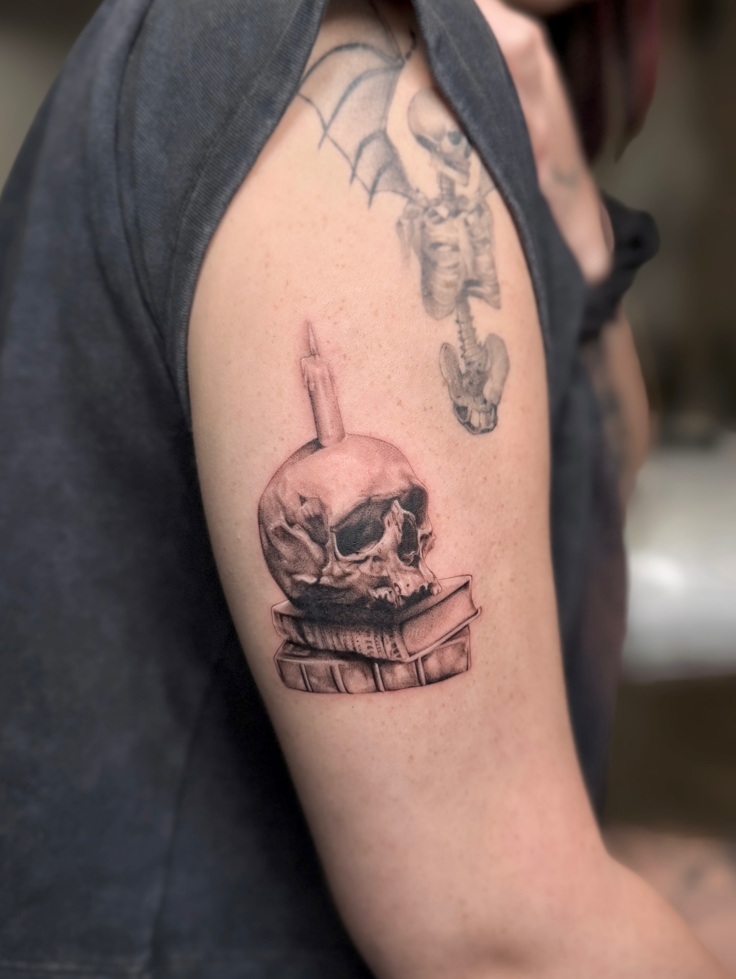 Skull reading book realism tattoo on the forearm by Valery Cardona