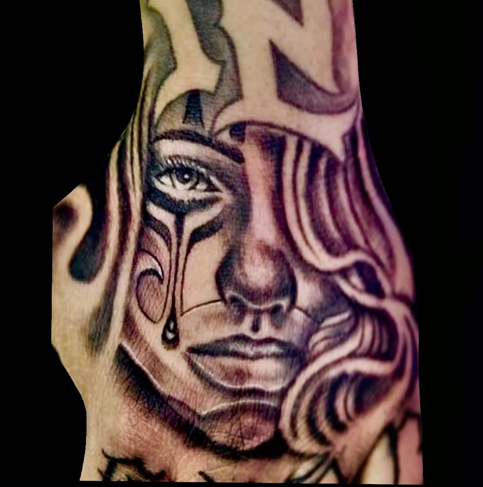 Man's face tribal tattoo on the forearm by Gessel Leticia Enriquez