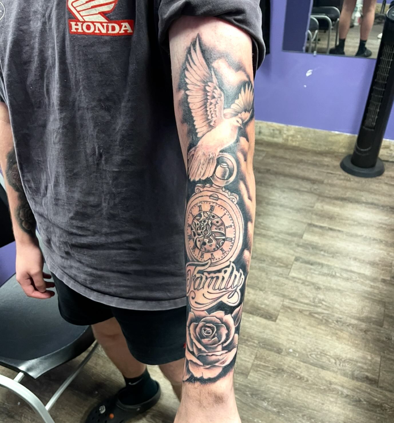 Clock, angel, rose, family American traditional tattoo on the forearm by Mark Calloway