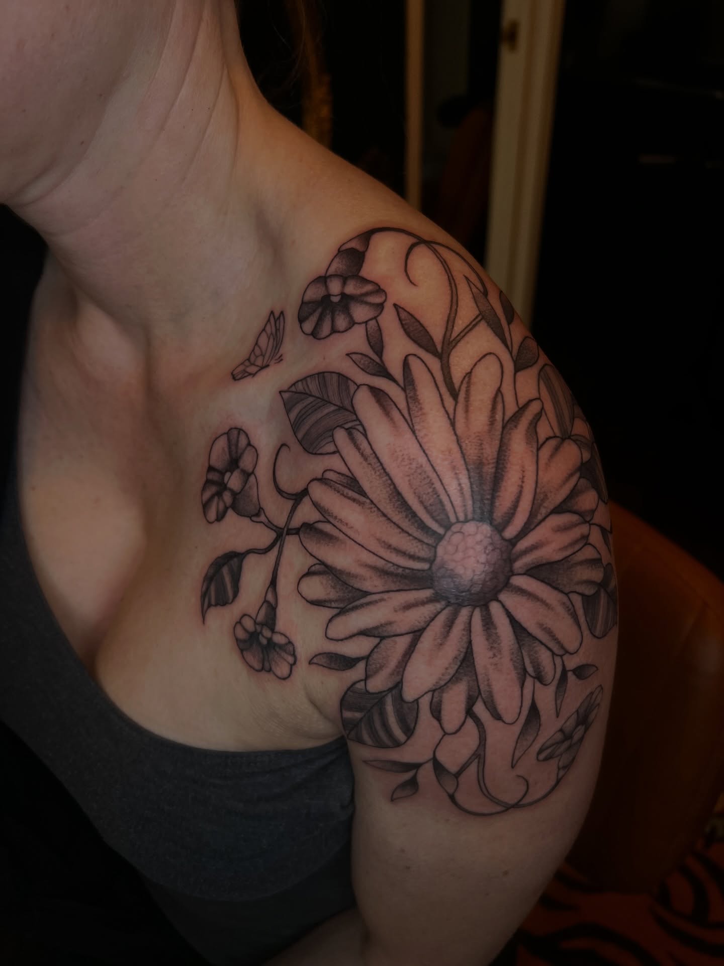 Flower black and grey tattoo on the shoulder by Vic Merkley