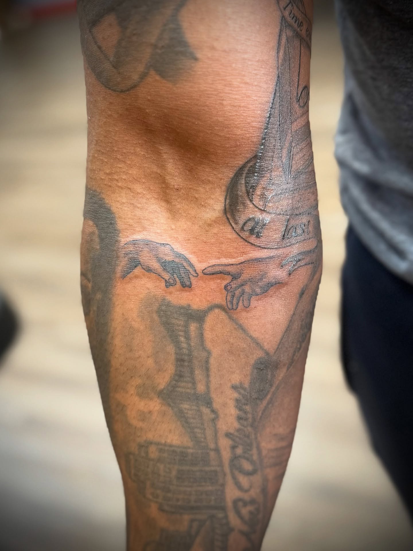 Creation scene black and grey tattoo on the forearm by Justin Bianchini - New Orleans Tattoo Artist