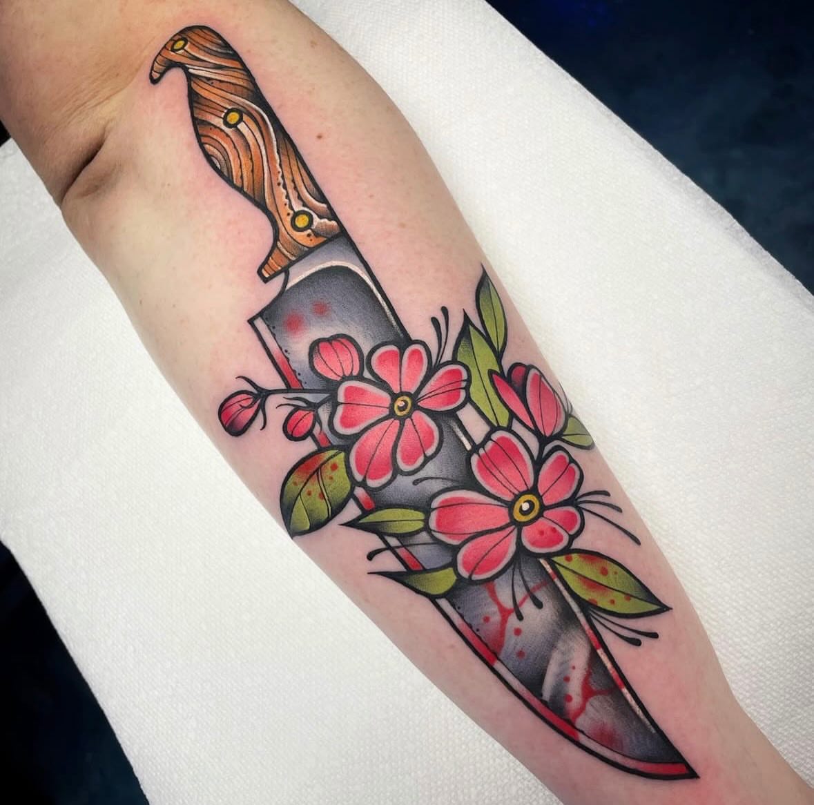 Knife and flowers American traditional tattoo on the forearm by Mark Boller
