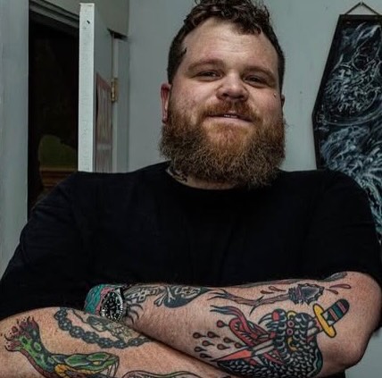 Bearded man American traditional tattoo on the forearm by Mark Boller