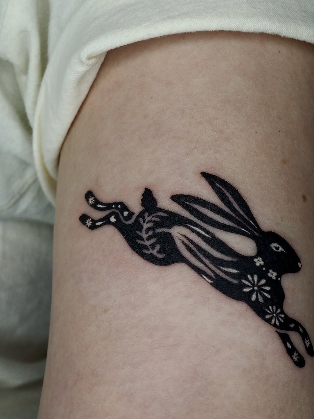 Running rabbit fine line tattoo on the thigh by A. Eye Tat