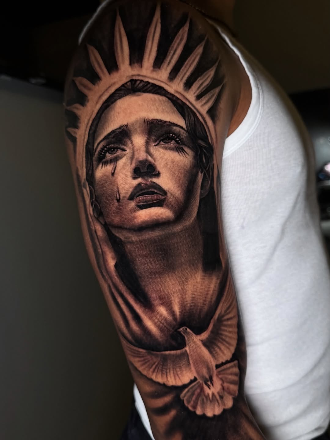Crying woman and dove Chicano tattoo on the forearm by Henry Fuentes