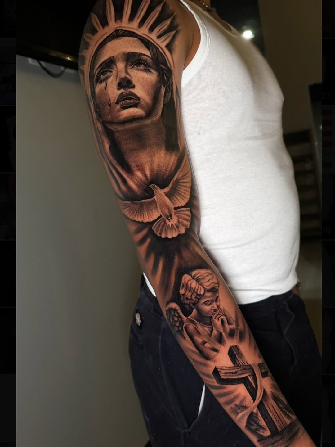 Religious imagery sleeve Chicano tattoo on the forearm by Henry Fuentes