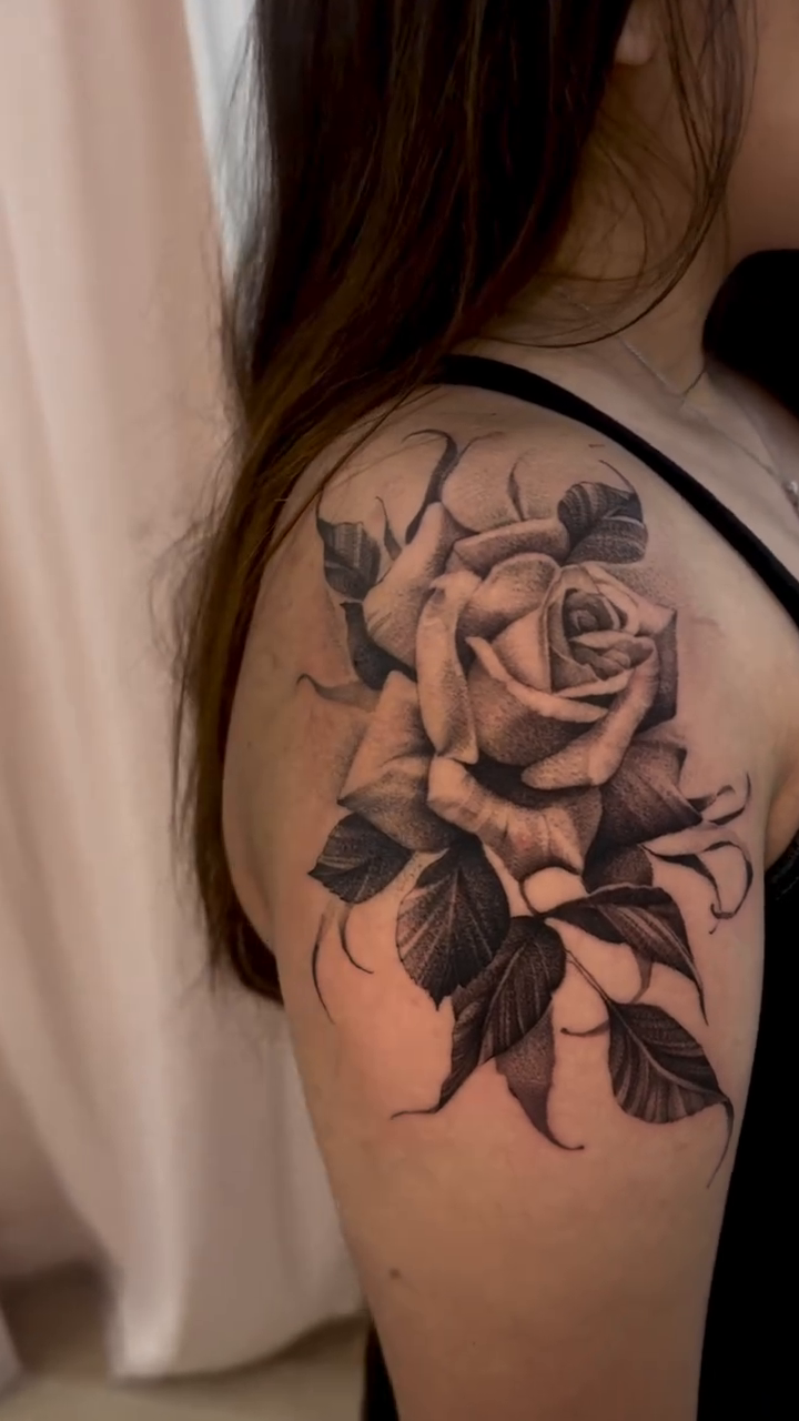 Rose with leaves realism tattoo by Claire Litsey
