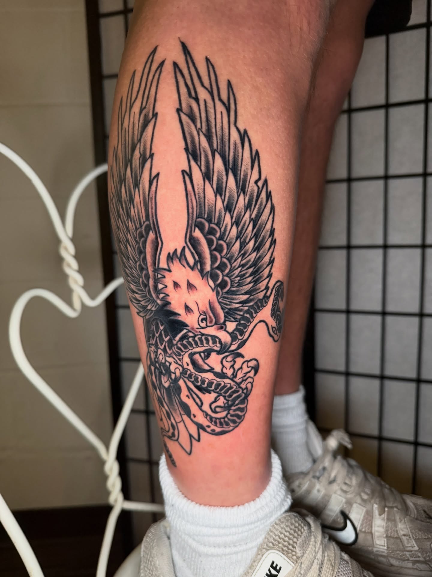 Winged dragon American traditional tattoo on the thigh by Austin Poliszuk, Minneapolis, Minnesota