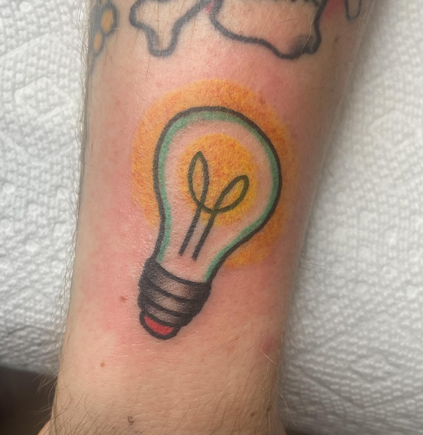Light bulb new school tattoo on the forearm by nicholas mcevoy, Boston, Massachusetts