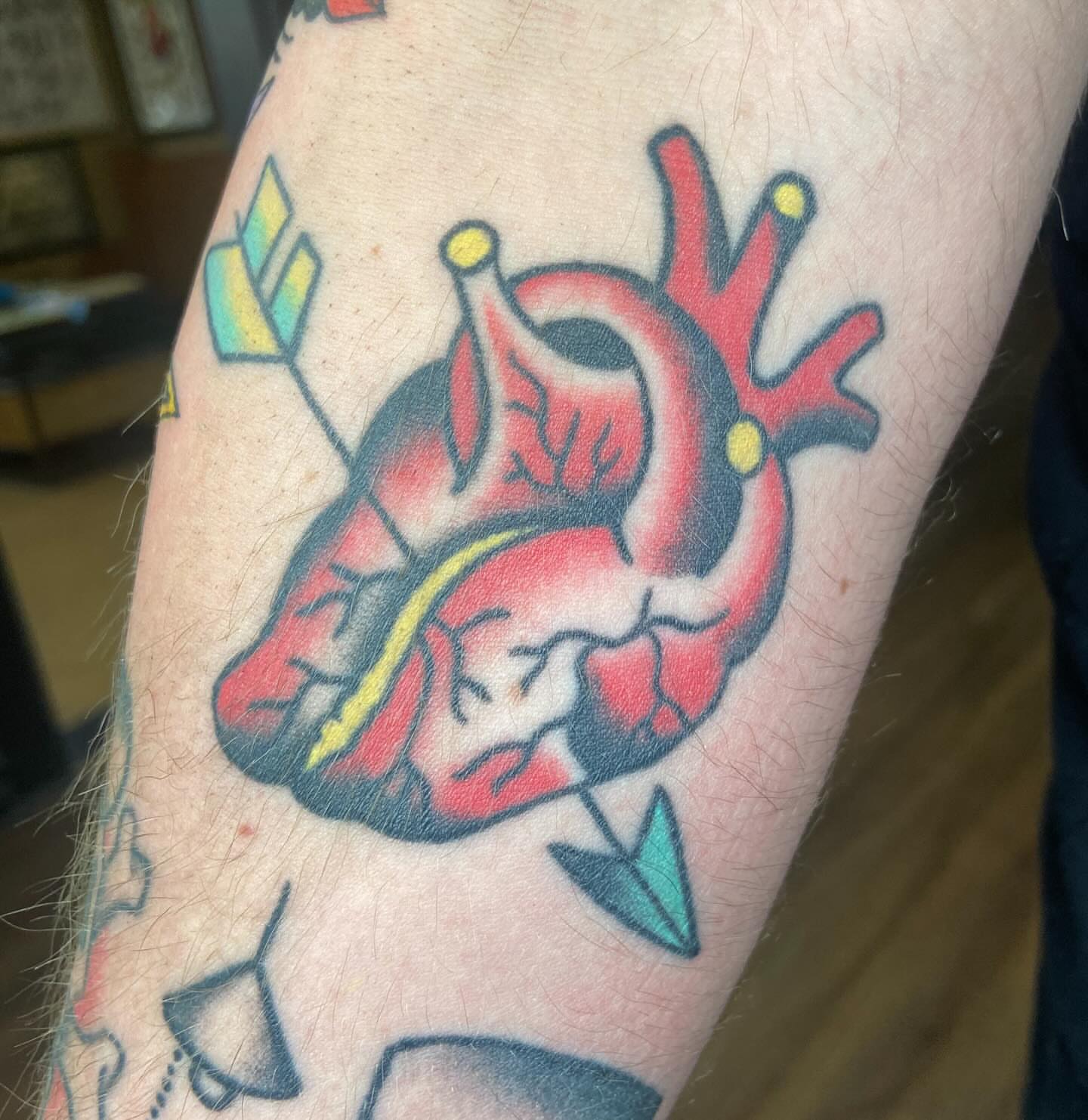 Heart with arrows American traditional tattoo on the forearm by nicholas mcevoy, Boston, Massachusetts